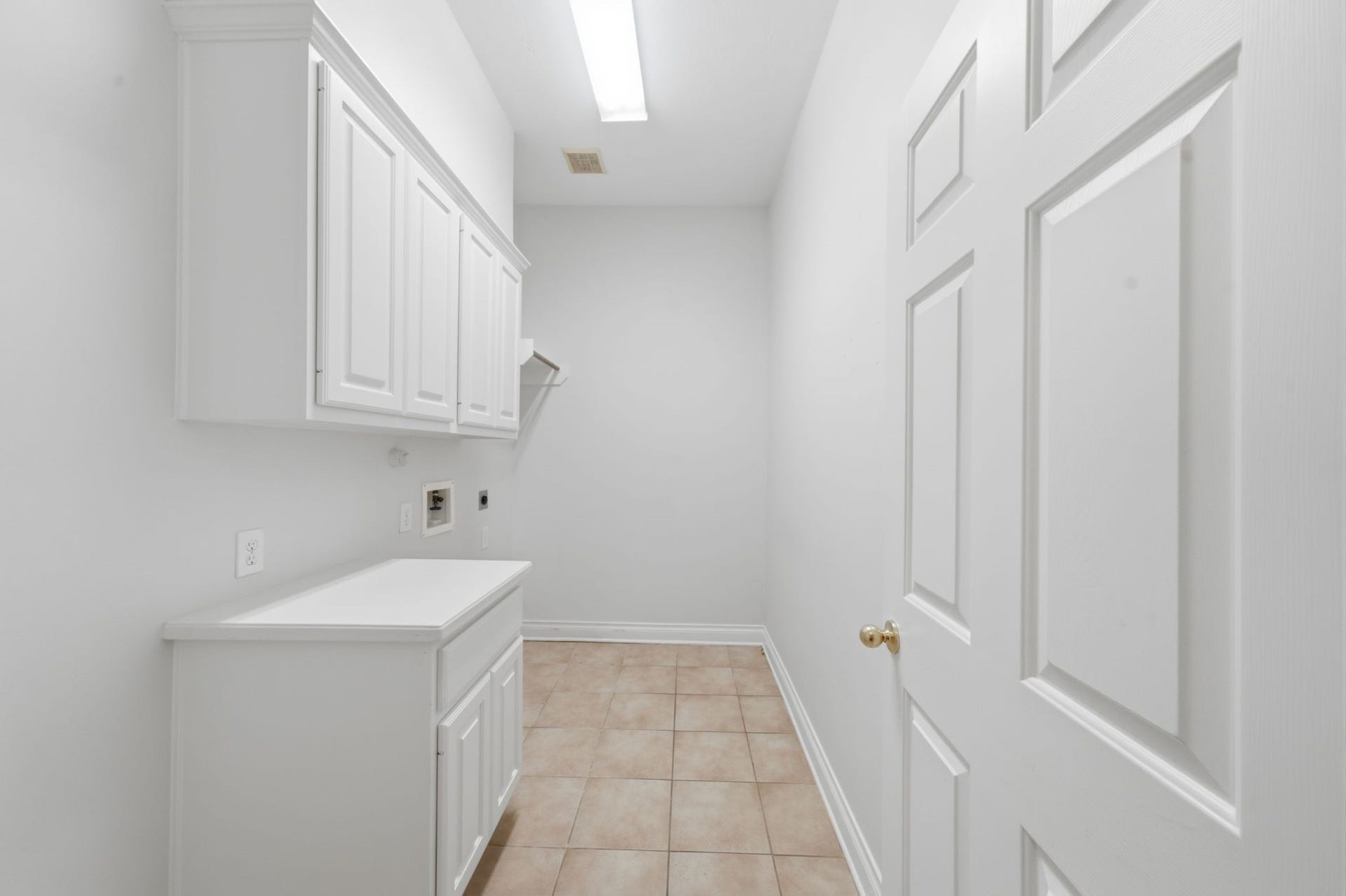 1227 Wellshire Drive, Katy, TX 77494 The utility room is tucked away behind the kitchen and offers built in storage and space for an additional refrigerator or freezer.