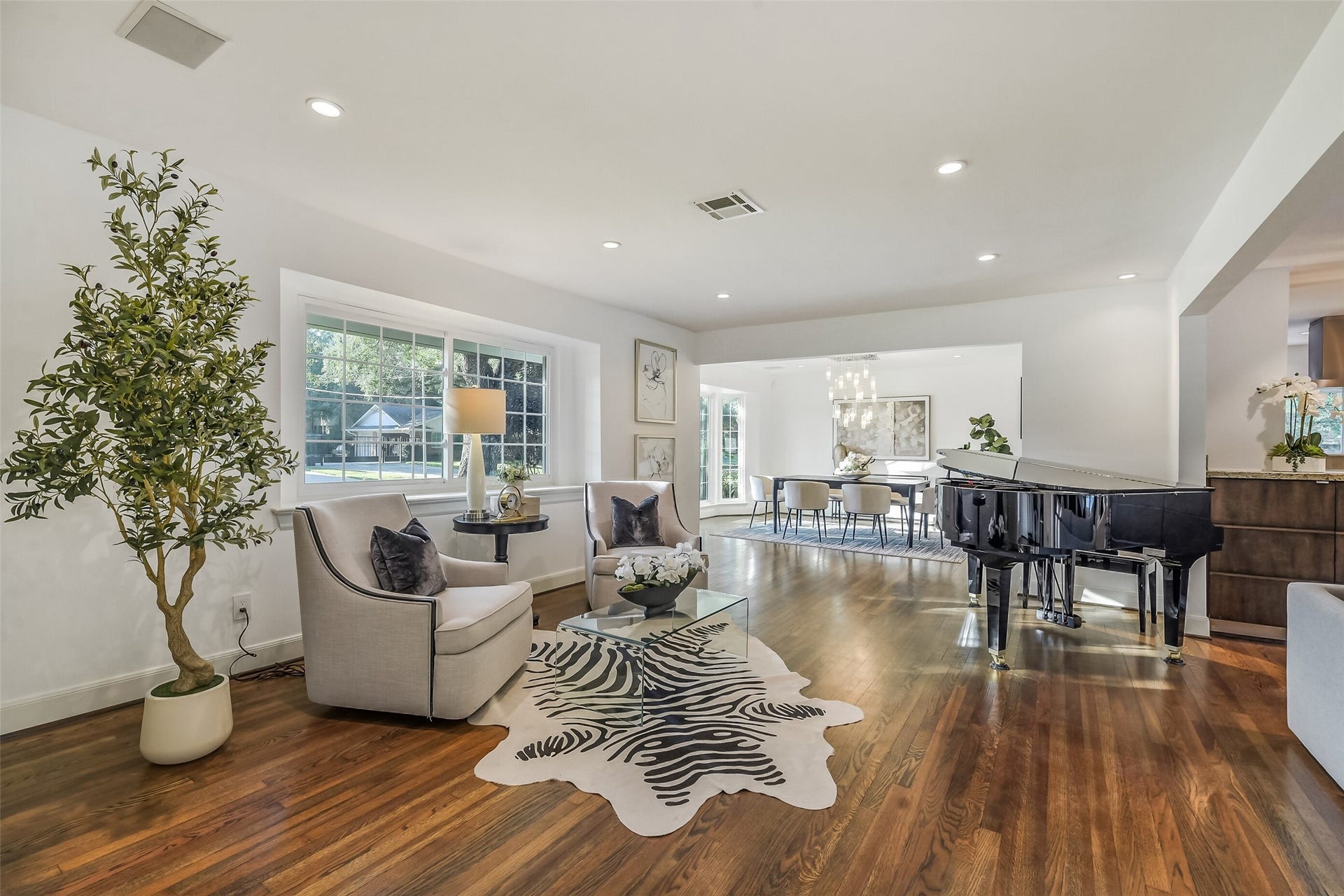 A bright and inviting formal living area welcomes you into the home, filled with natural light and thoughtfully designed to flow seamlessly into the formal dining room, family room, and kitchen.
