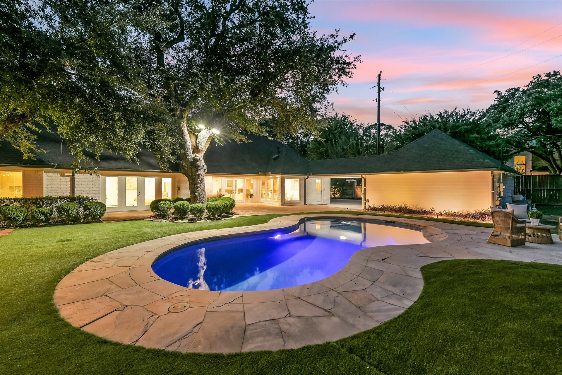 Another view of the stunning backyard with views looking towards the home and the oversized 2-car detached garage.