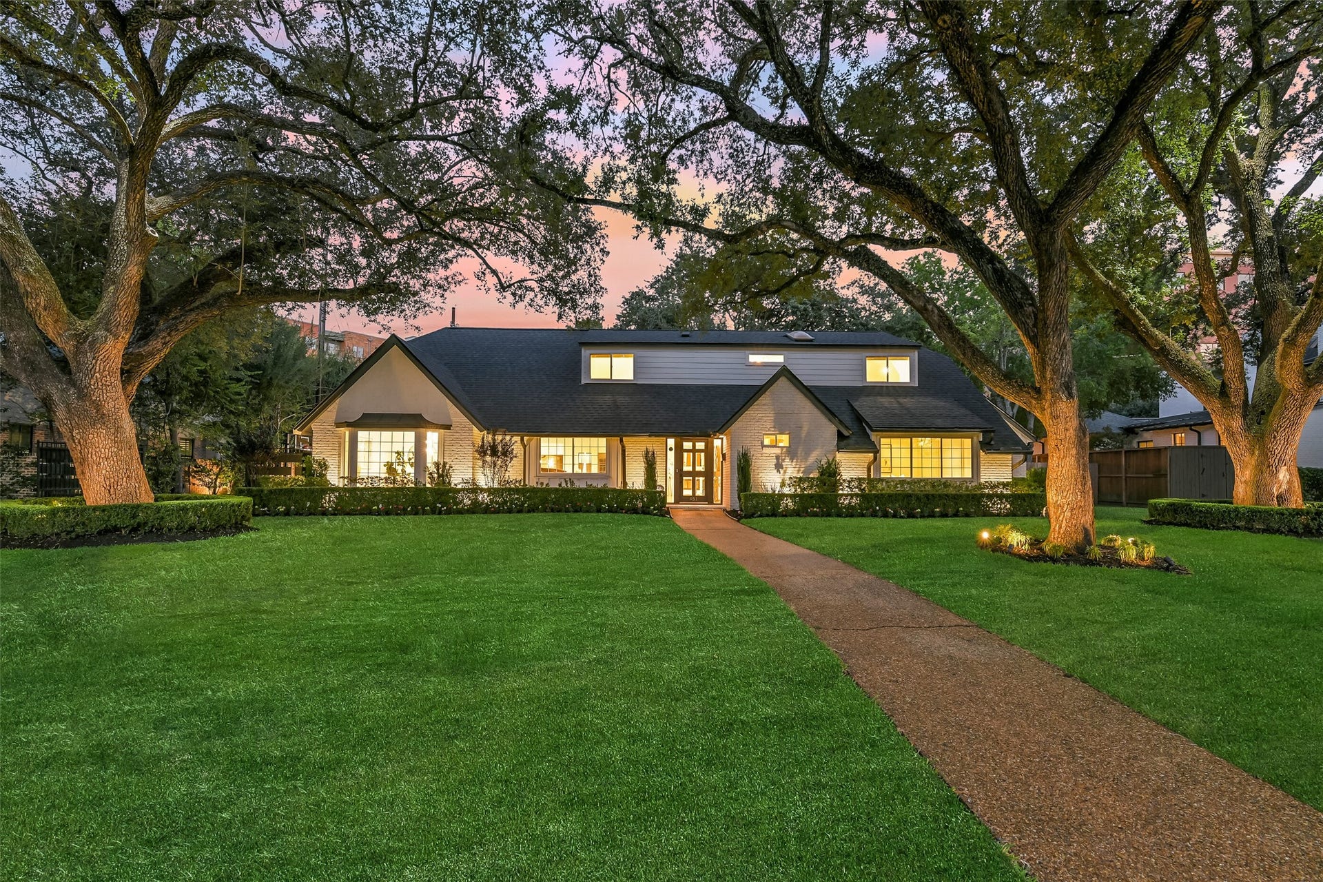Welcome to 451 Brown Saddle! This timeless English country charm meets modern sophistication in the heart of Tanglewood, framed by majestic, mature oak trees and surrounded by llush, manicured grounds.