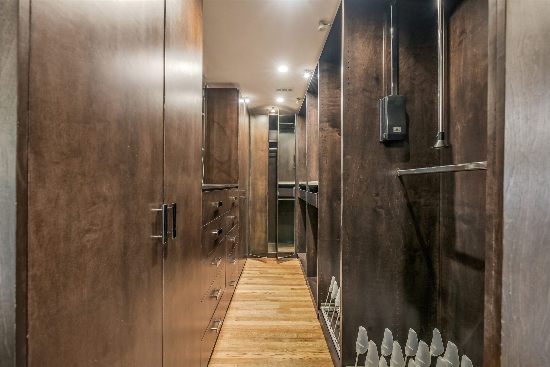 Expansive walk-in primary closet thoughtfully designed with built-in shelving, hanging space, and exceptional organization.