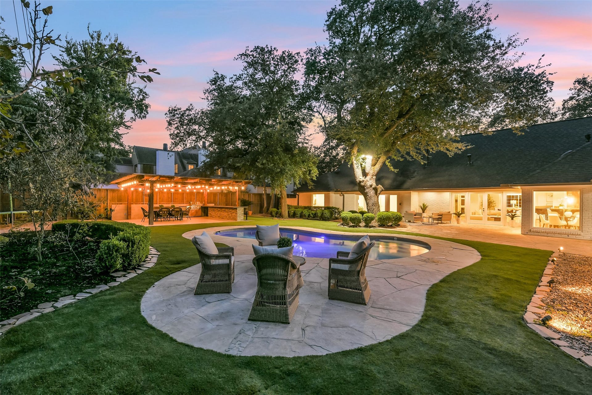 An entertainers paradise! This beautifully landscaped backyard features lush turf, a sparkling pool, and a covered outdoor entertaining pavilion with a built-in kitchen and dining area. The inviting seating area is equipped with a gas connection for a future fire pit, creating the perfect setting for gatherings and outdoor enjoyment year-round.