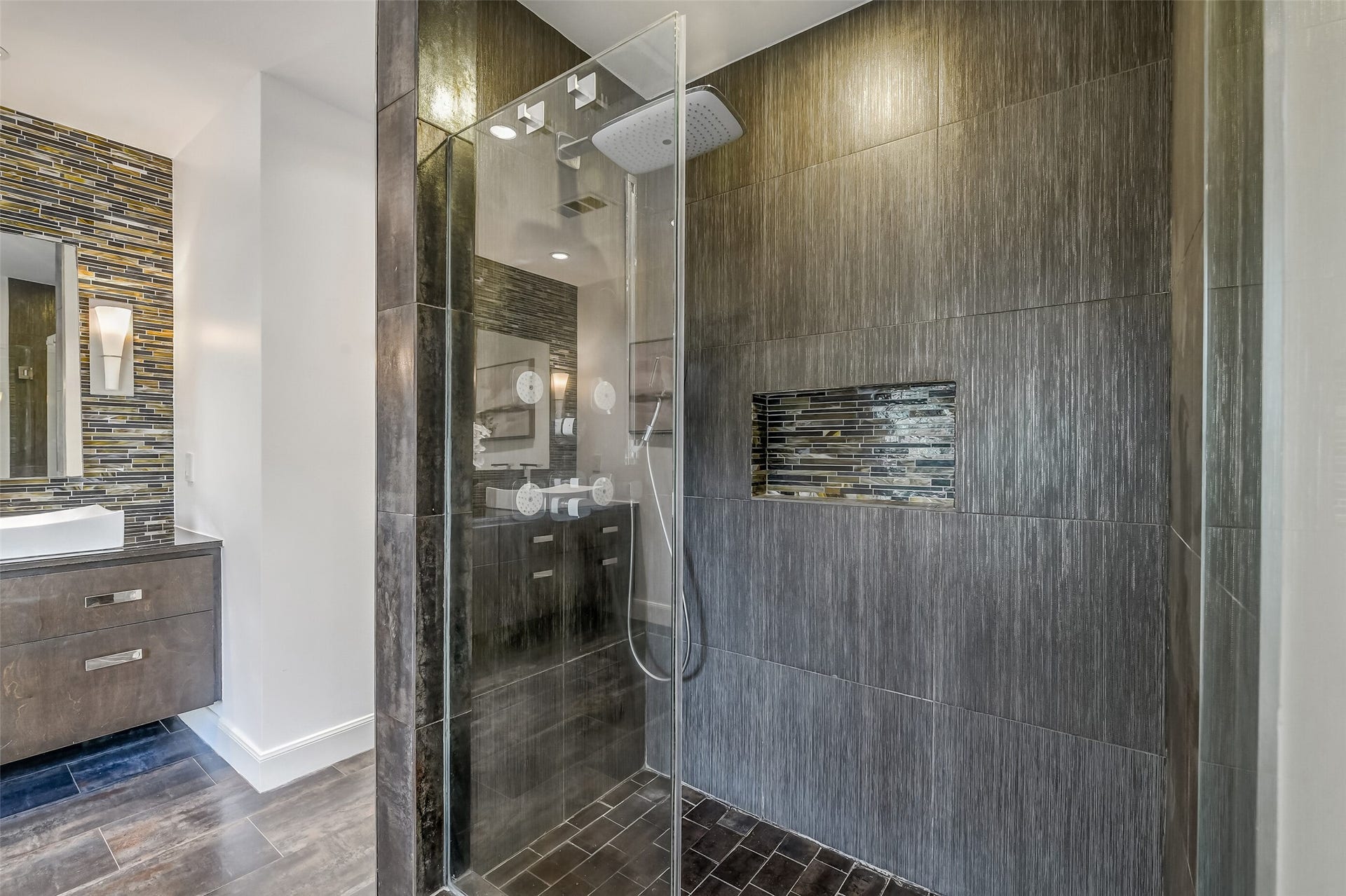 Luxurious, generously sized glass-enclosed walk-in shower with sleek fixtures and pristine tile surround, creating a spa-like retreat.
