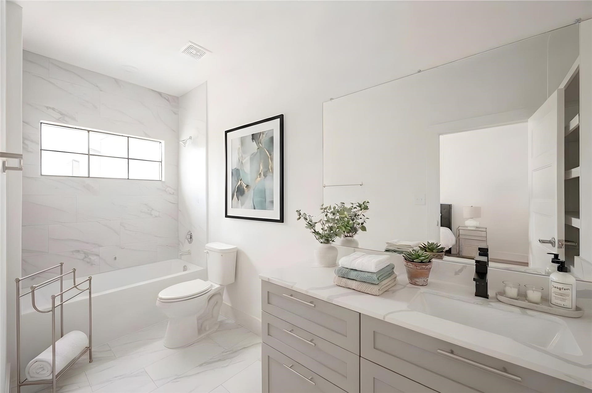 Easy-maintenance bathroom featuring modern wall panels instead of traditional grout lines. [virtual stage]