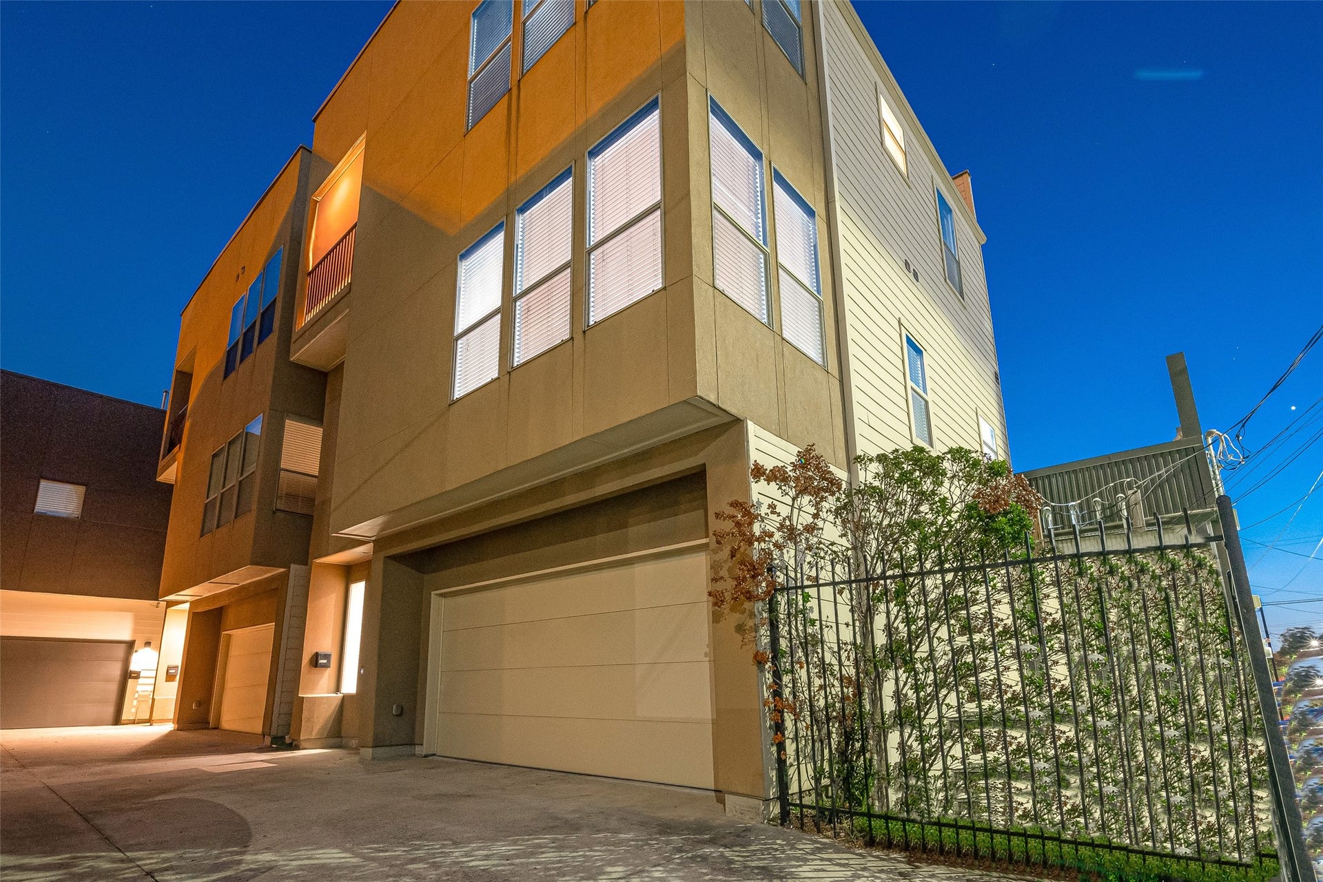 5111 Cornish Street, Houston, TX 77007 Modern multi-story home with large windows and an attached garage, set in a well-lit urban neighborhood.