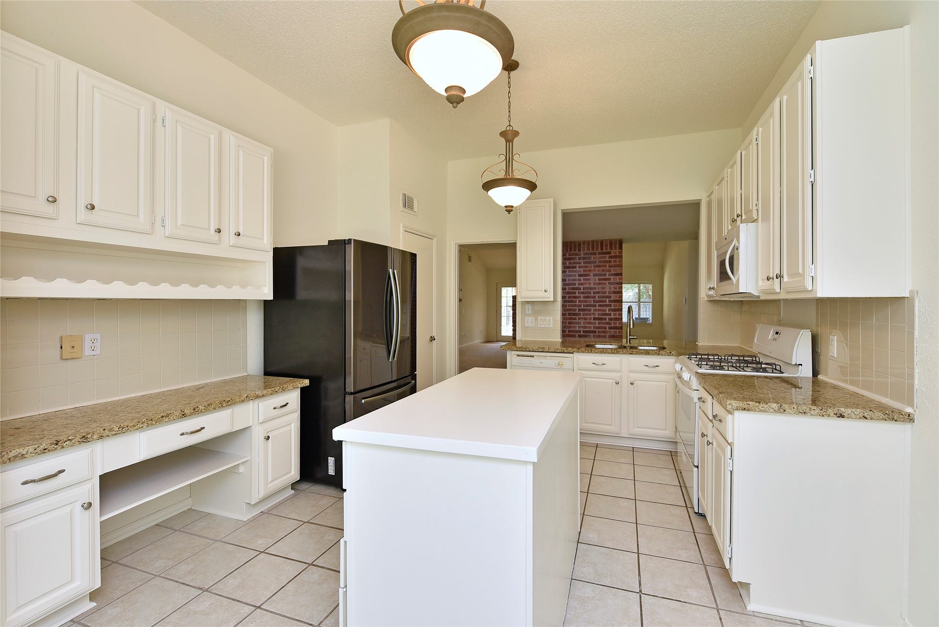 2035 Shorewood Lane, Sugar Land, TX 77479 Island kitchen with built in desk, lots of storage. Stainless refrigerator can stay.