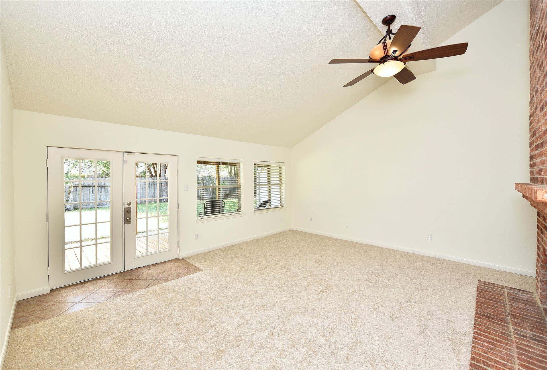 2035 Shorewood Lane, Sugar Land, TX 77479 Spacious living room with backyard views of nature.