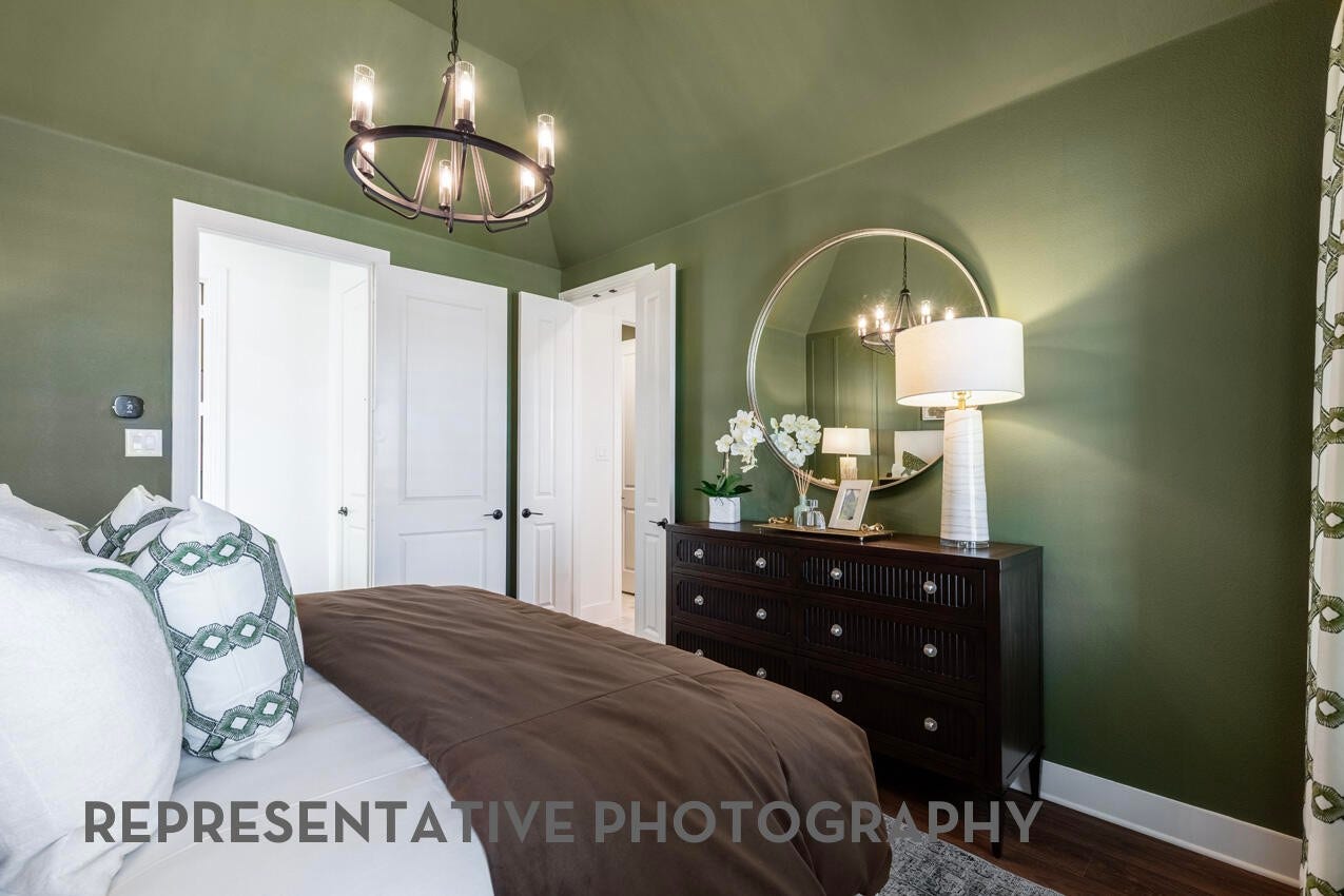 3435 Loam Lane, Richmond, TX 77406 A serene primary bedroom features elegant French doors that open into the primary bathroom, creating a private and seamless retreat.