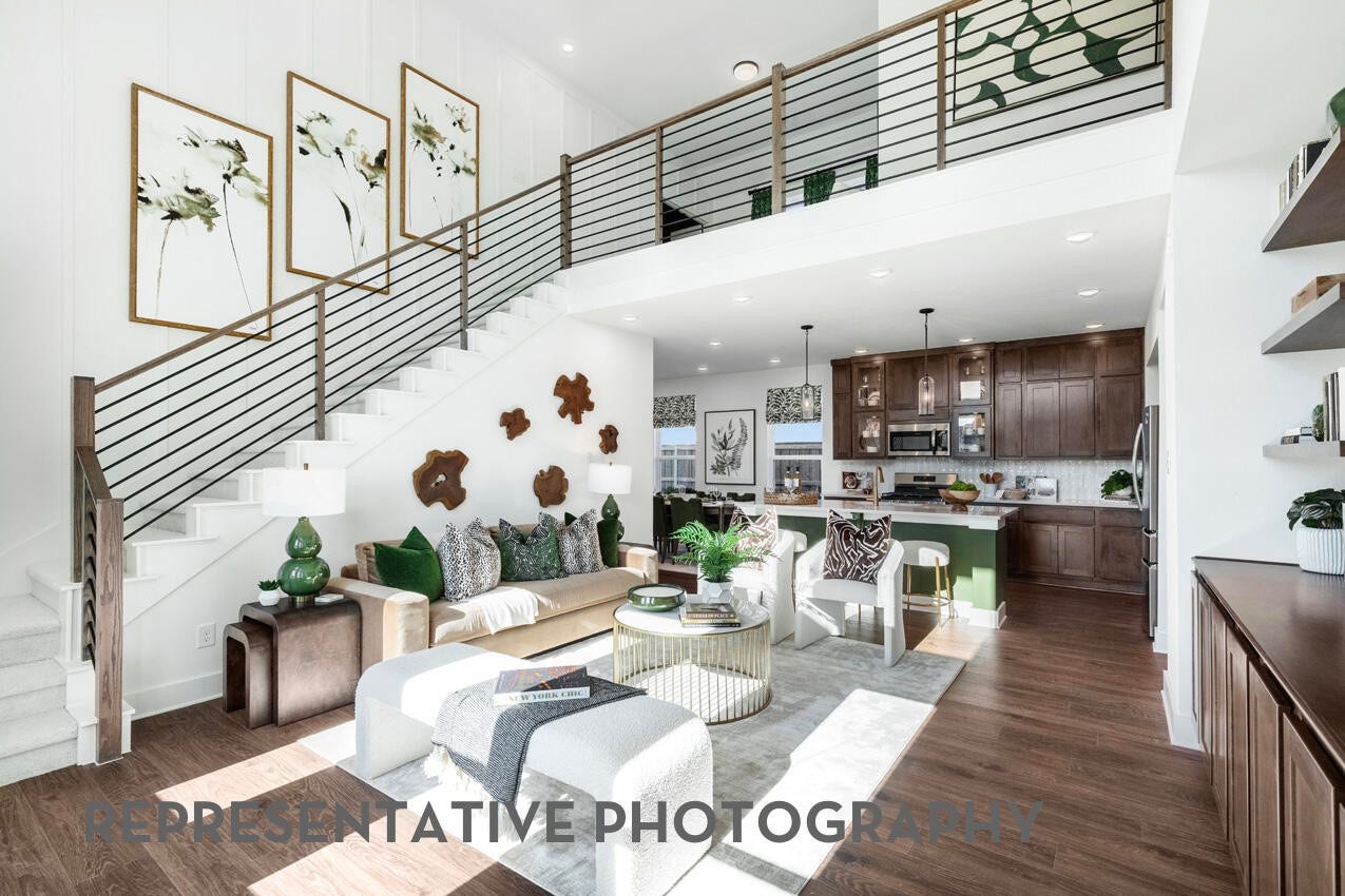 3435 Loam Lane, Richmond, TX 77406 A spacious family room with high ceilings and large windows fills the space with natural light, creating a warm and inviting place to gather.