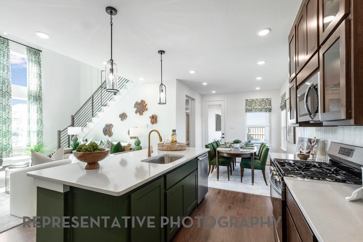 3435 Loam Lane, Richmond, TX 77406 A welcoming kitchen flows into a nearby dining room, creating a seamless space for gathering, sharing meals, and entertaining.