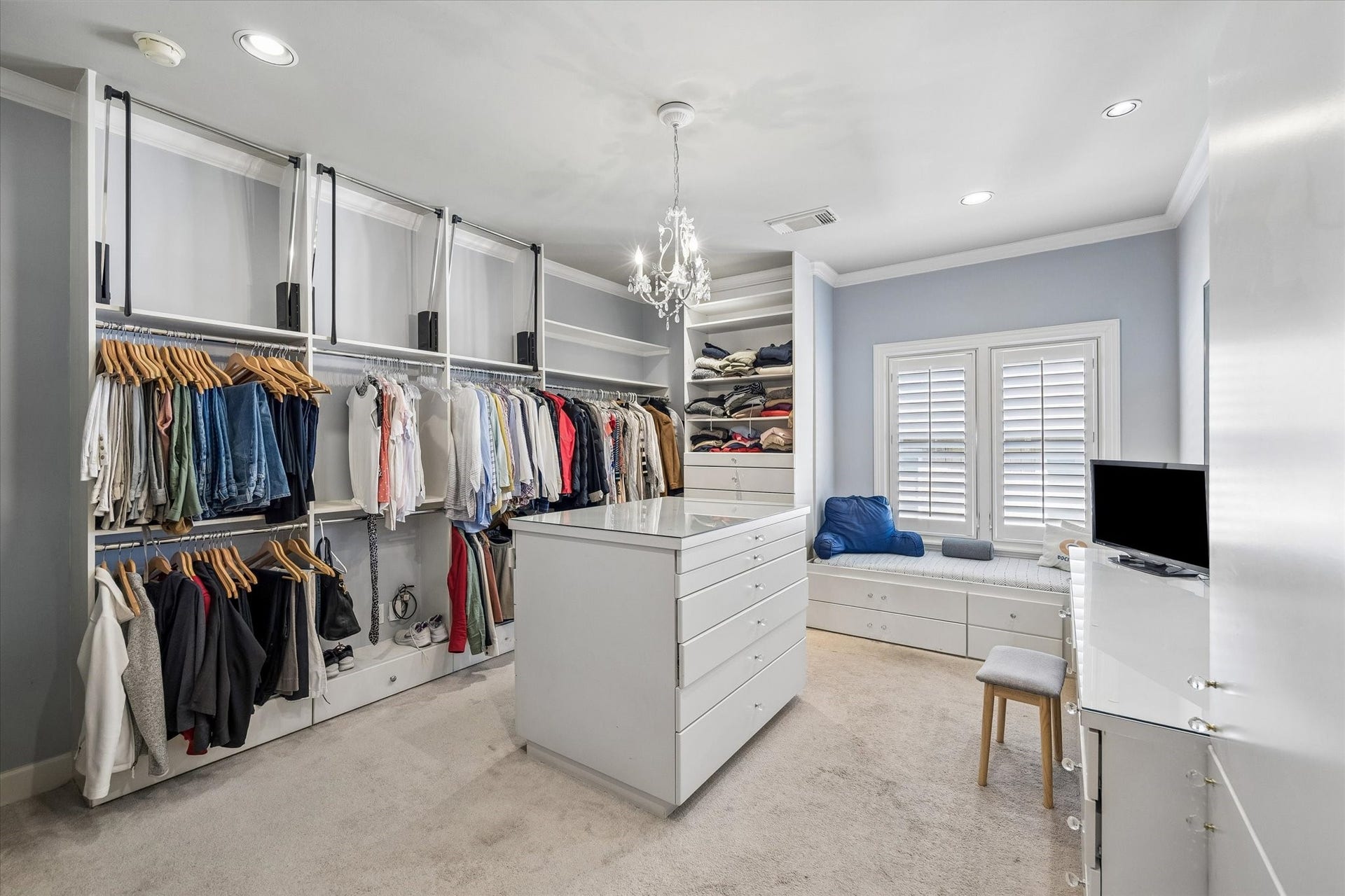 Bedroom converted into this AMAZING CLOSET.  Desk area, packing island & bench.