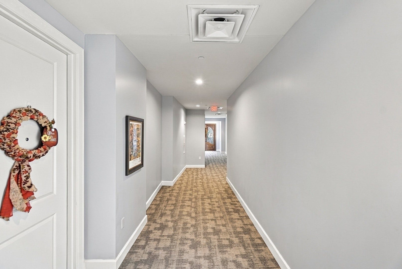3 Waterway Court, #2D, The Woodlands, TX 77380 Bright interior corridor featuring neutral finishes and a clean, well-maintained appearance.
