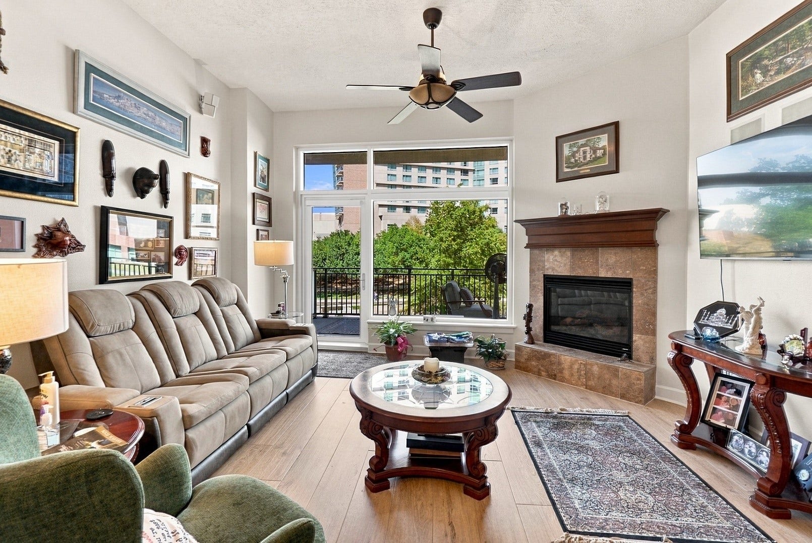 3 Waterway Court, #2D, The Woodlands, TX 77380 Natural light fills this comfortable living space, complete with a cozy fireplace and beautiful outdoor views.