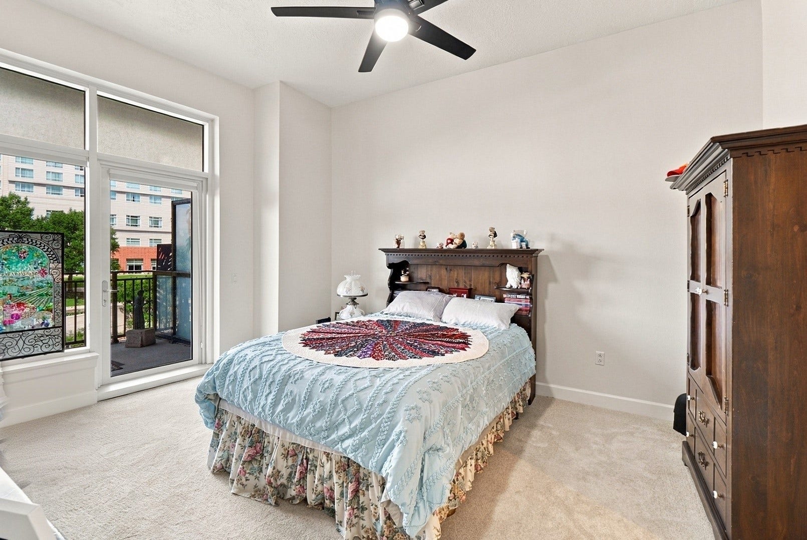 3 Waterway Court, #2D, The Woodlands, TX 77380 Spacious bedroom with soft natural light, a ceiling fan, and access to the private balcony.