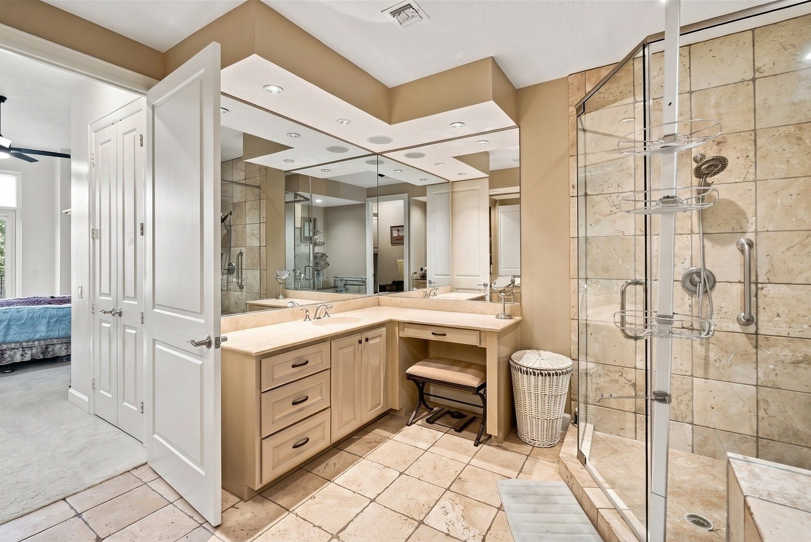 3 Waterway Court, #2D, The Woodlands, TX 77380 Expansive bathroom featuring dual vanities, a separate shower, and a relaxing soaking tub.