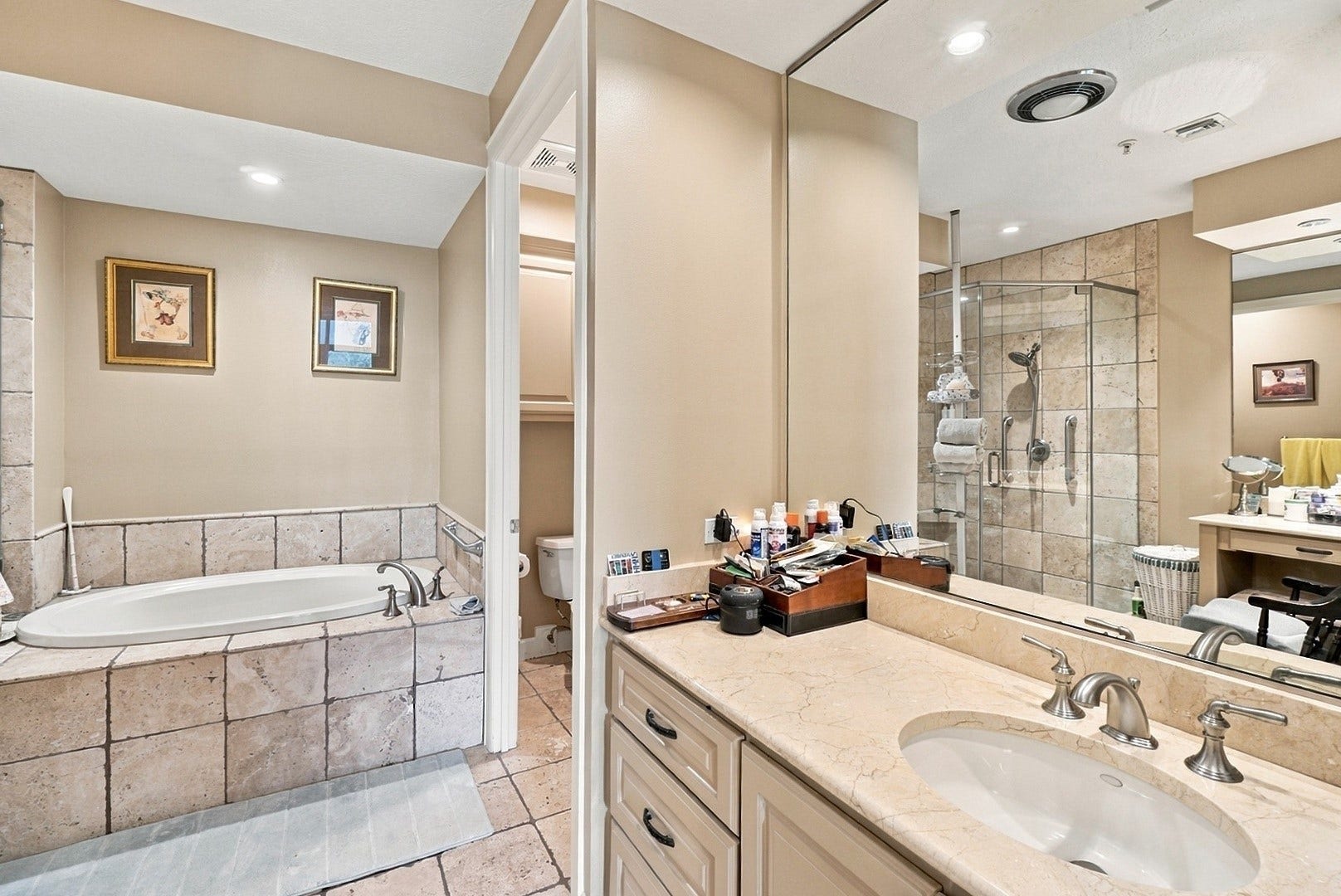 3 Waterway Court, #2D, The Woodlands, TX 77380 Beautifully designed bathroom featuring a soaking tub, separate glass-enclosed shower, and spacious vanity.
