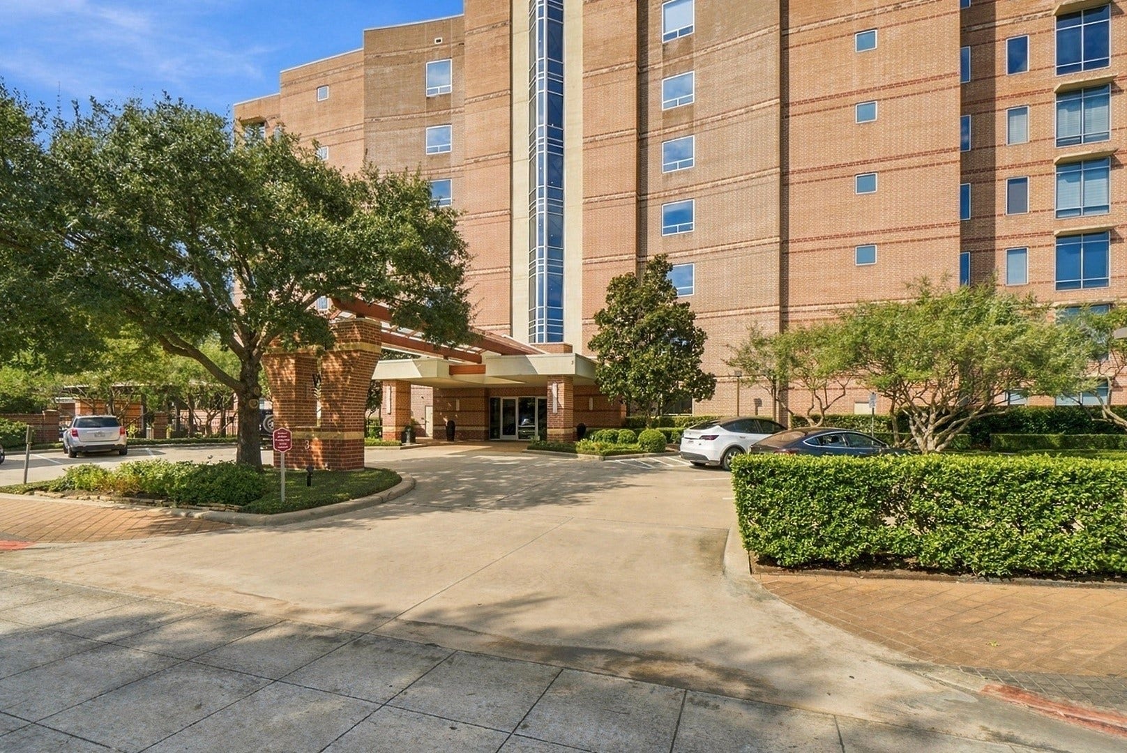 3 Waterway Court, #2D, The Woodlands, TX 77380 Beautiful condominium exterior surrounded by mature trees, manicured landscaping, and welcoming grounds.