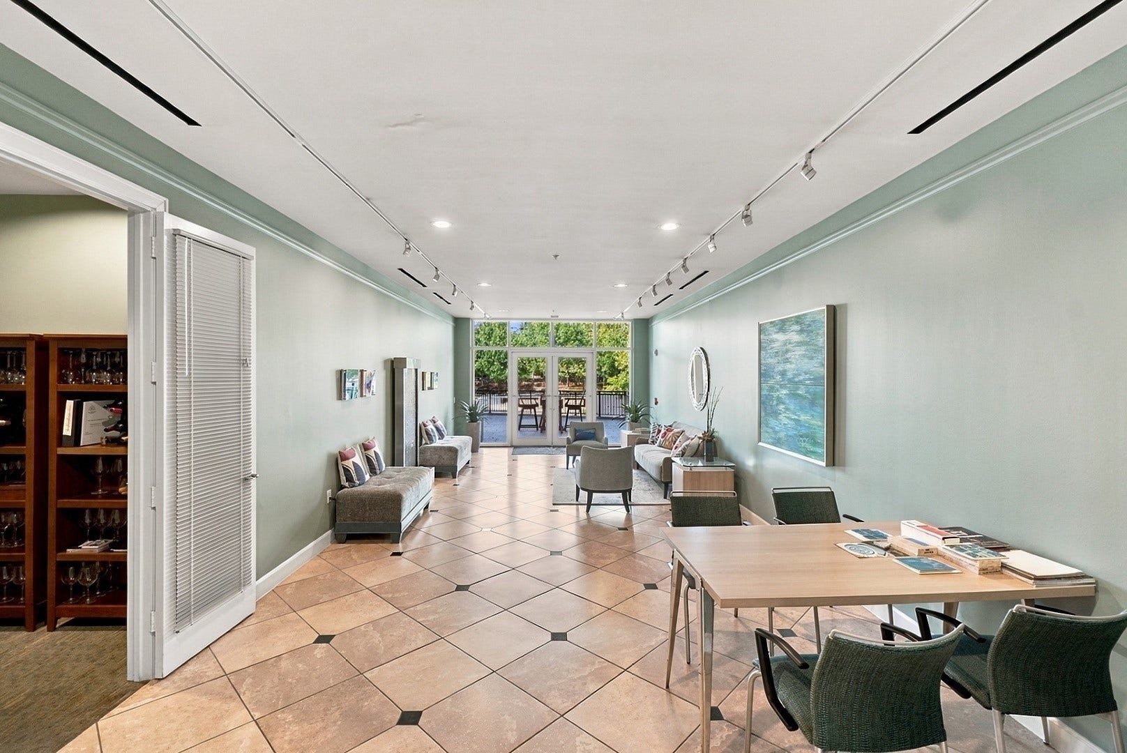 3 Waterway Court, #2D, The Woodlands, TX 77380 Spacious common area with abundant natural light, elegant tile flooring, and inviting seating arrangements.