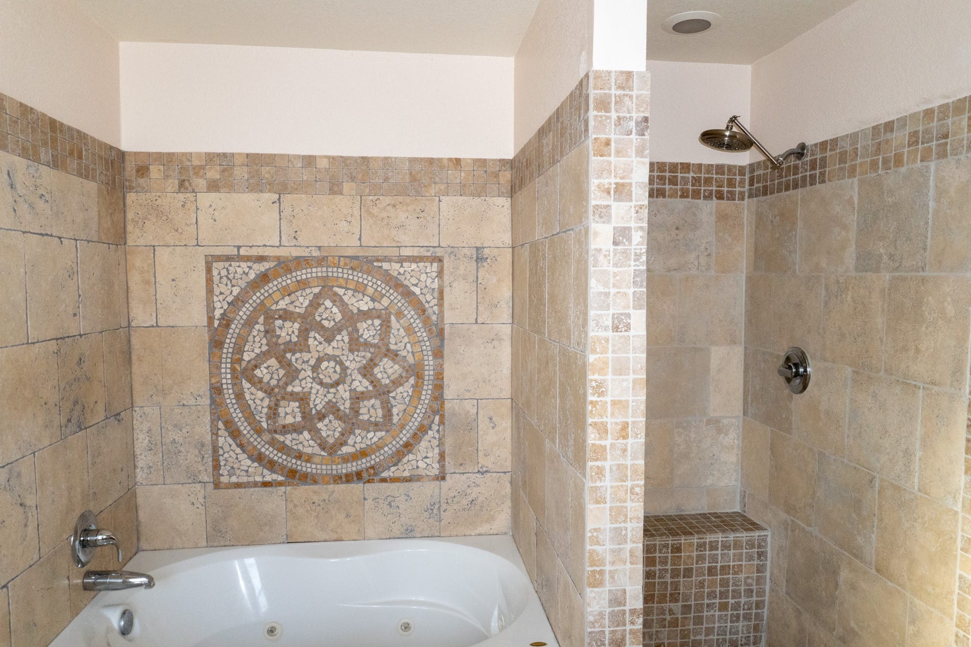 7627 Greenwood Point Drive, Cypress, TX 77433 Luxurious bathroom featuring a beautifully tiled soaking tub and a spacious walk-in shower, enhanced by intricate mosaic details.
