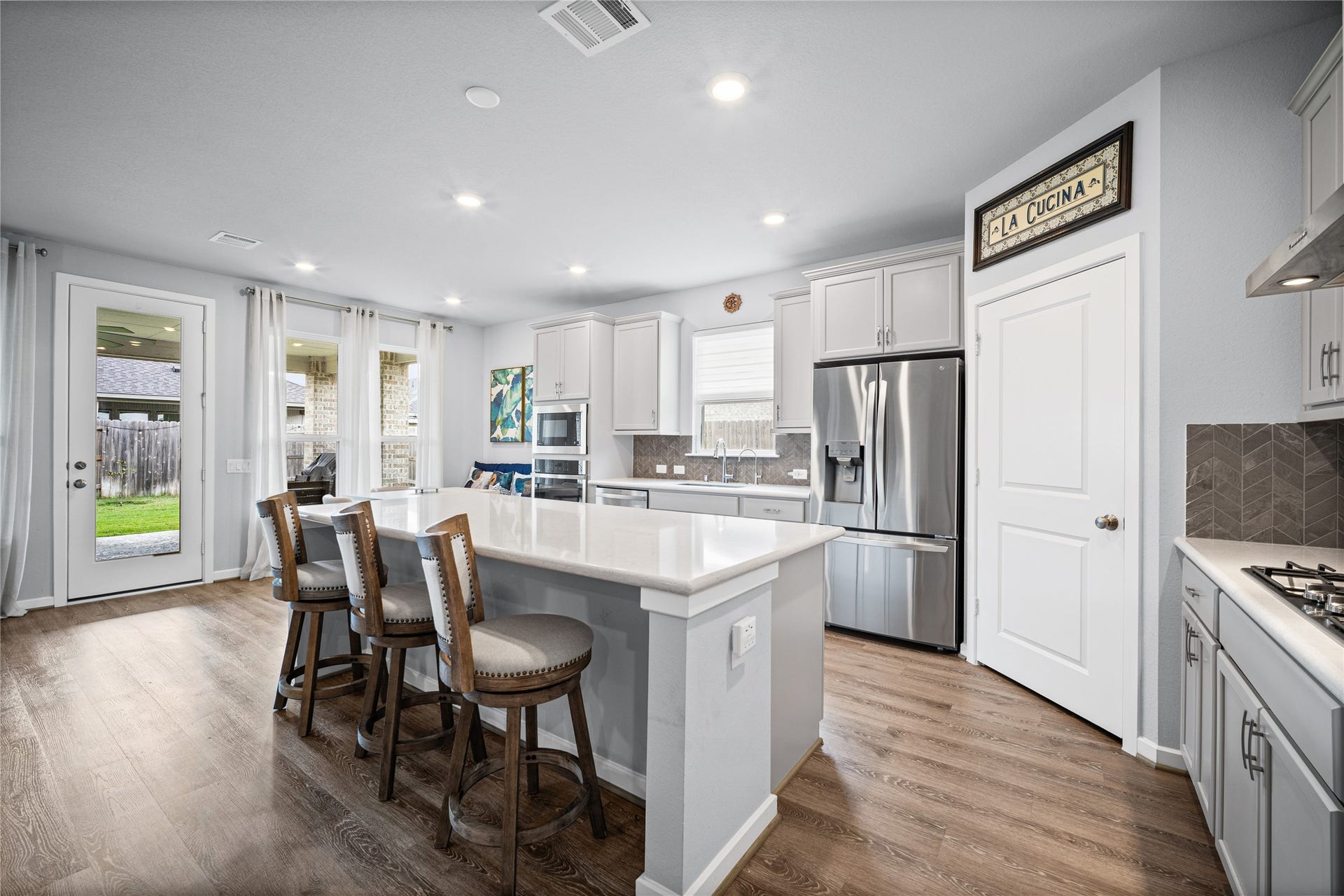 The kitchen opens beautifully to the surrounding living spaces, making everyday routines feel connected and comfortable.