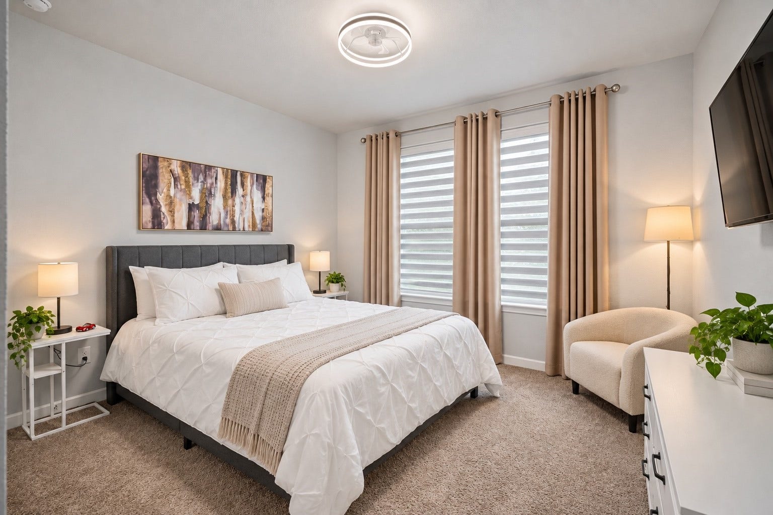 A comfortable secondary bedroom offers soft natural light and flexible space for family or guests.