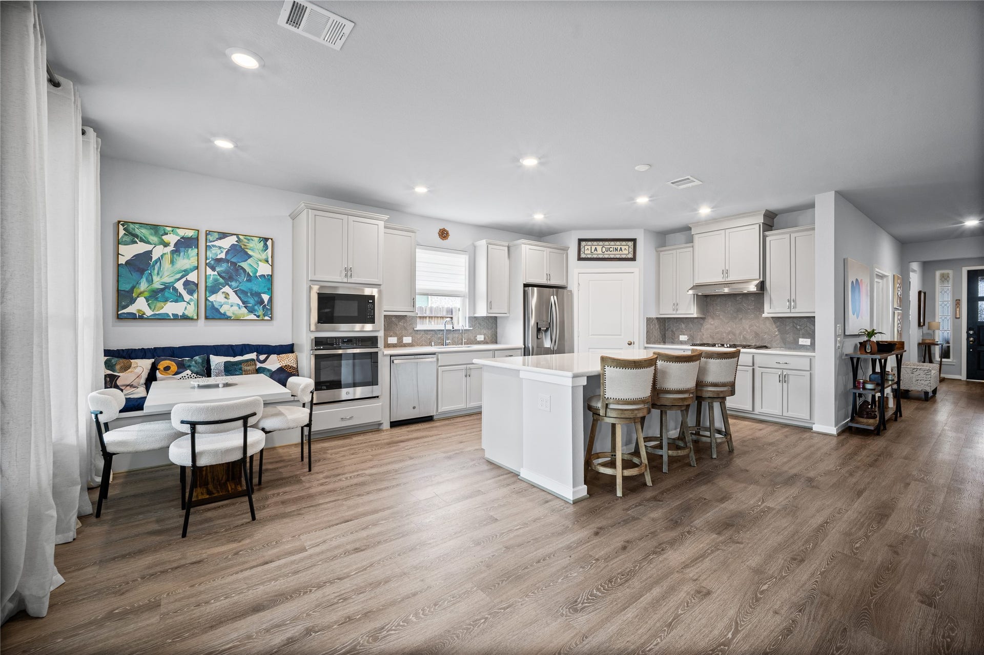 The dining area offers a comfortable gathering space, complemented by a custom-added breakfast nook bench.