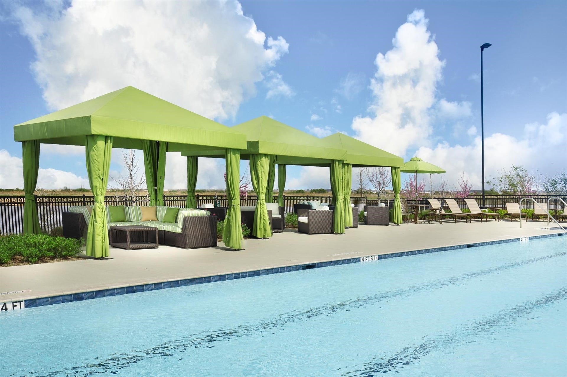 Shaded cabanas and resort-style surroundings create the perfect setting to relax and enjoy the day.