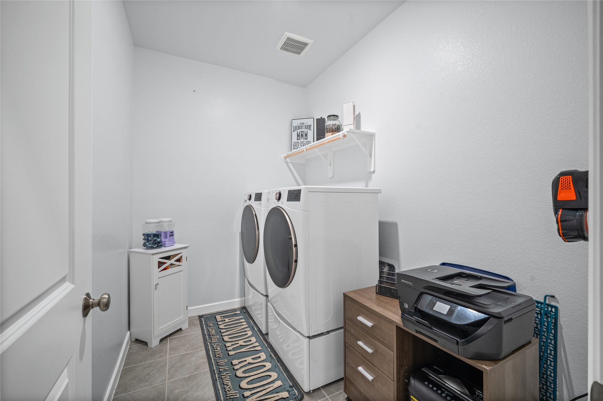 The dedicated utility room keeps everyday laundry needs organized and conveniently tucked away.