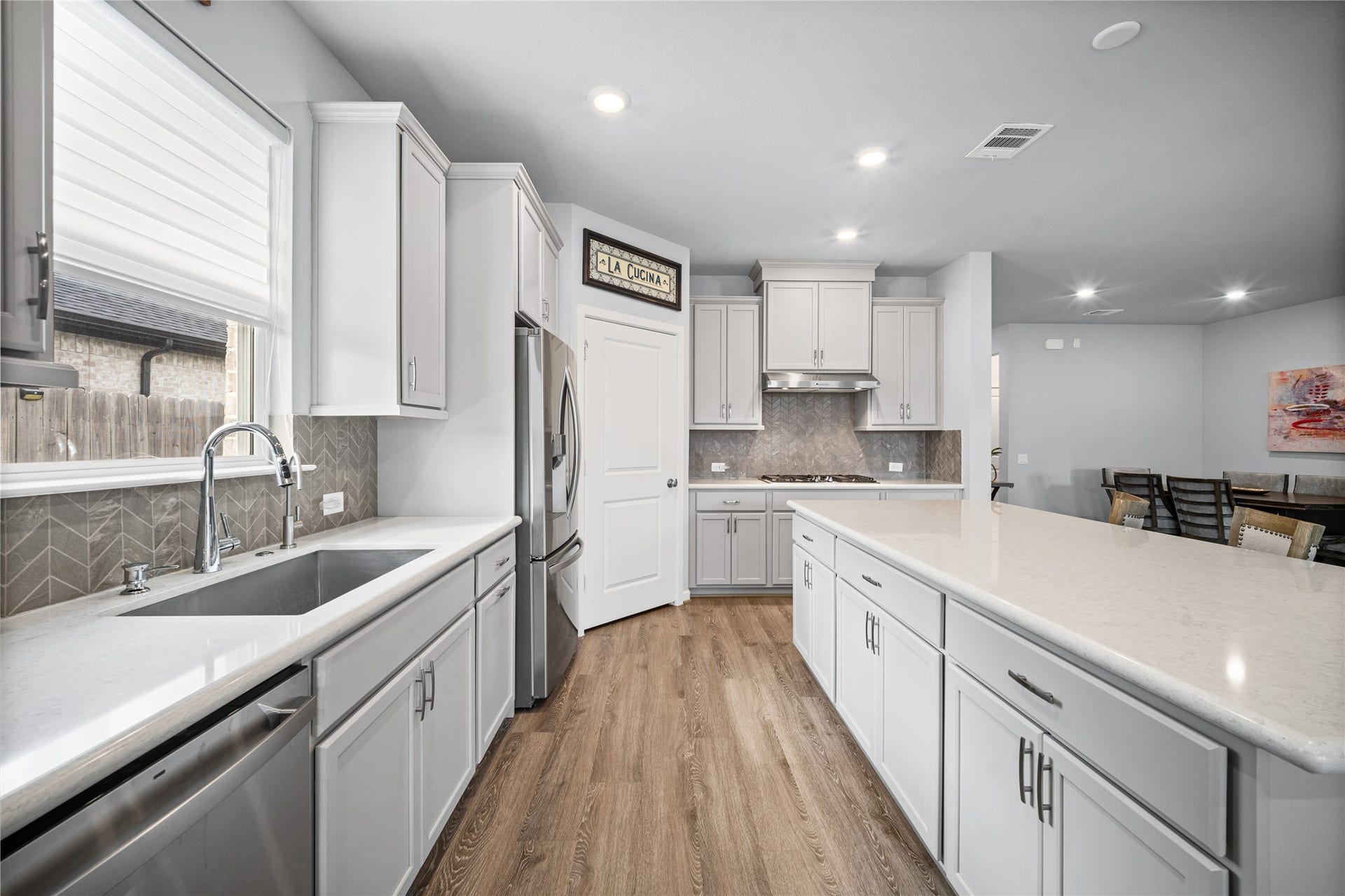 A bright, well-designed kitchen offers generous cabinetry, ample workspace and a clean, timeless look.