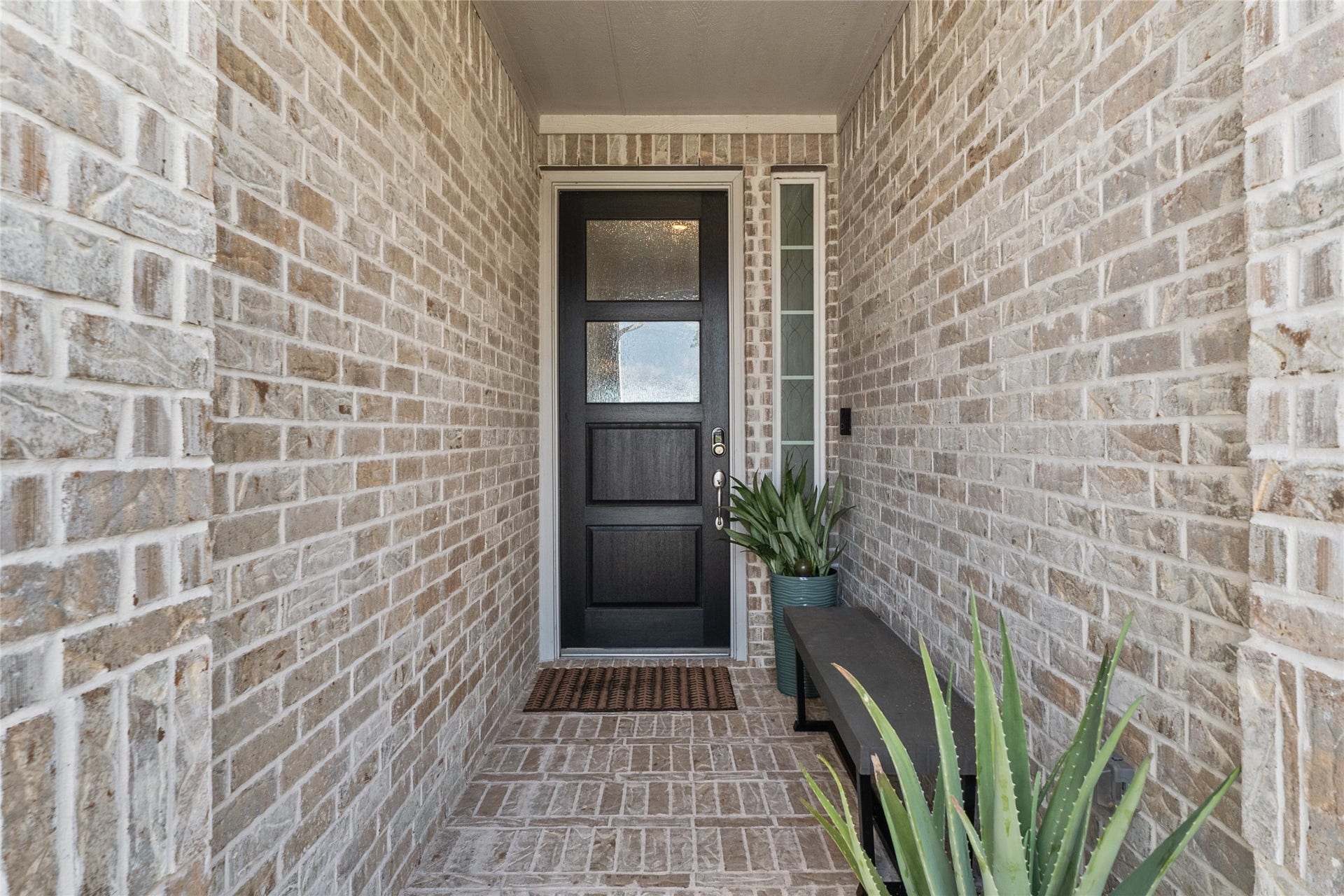 A charming covered entry and upgraded front door offer a warm welcome home.
