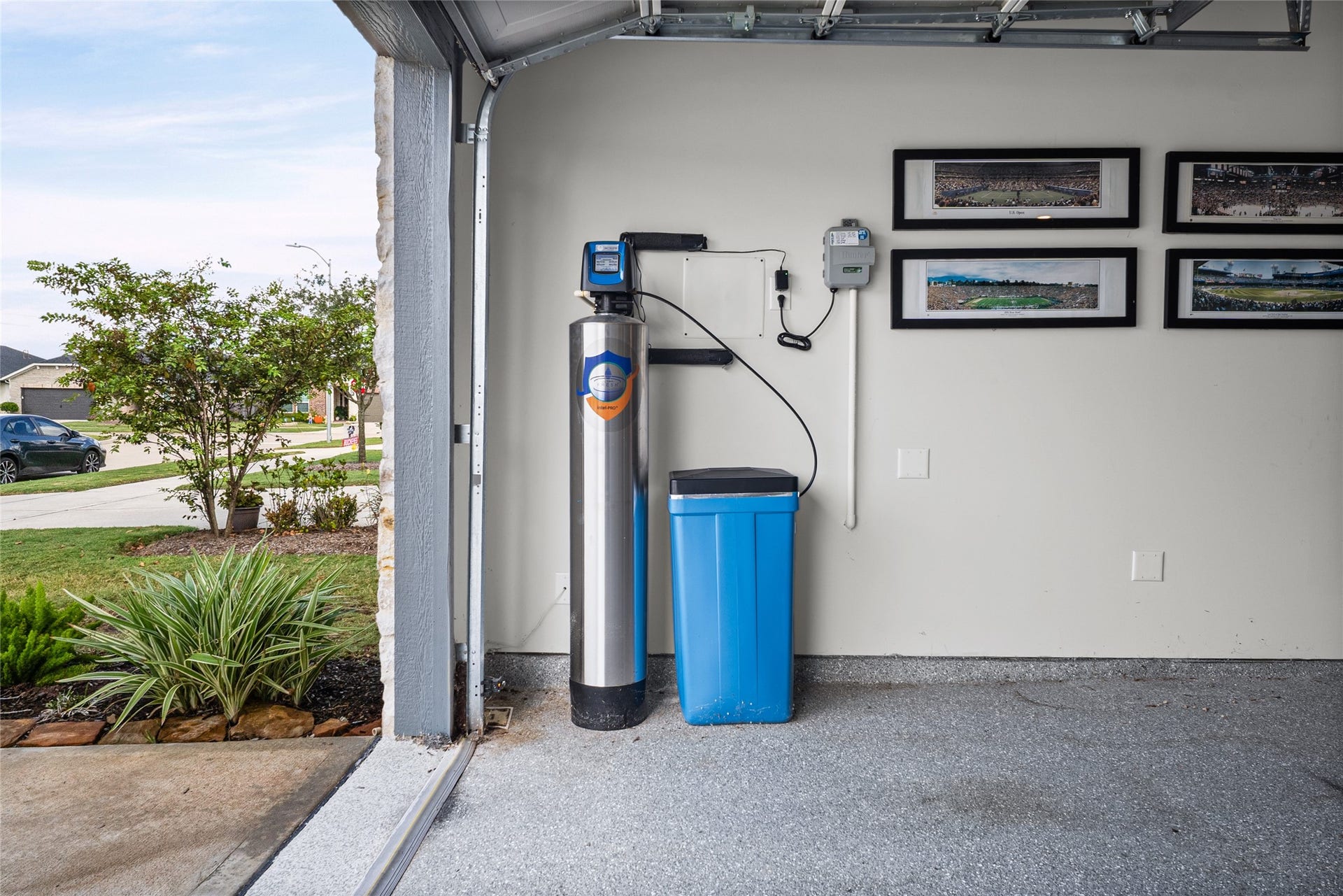 The garage includes a whole-home water conditioning system along with useful space for storage and everyday needs.