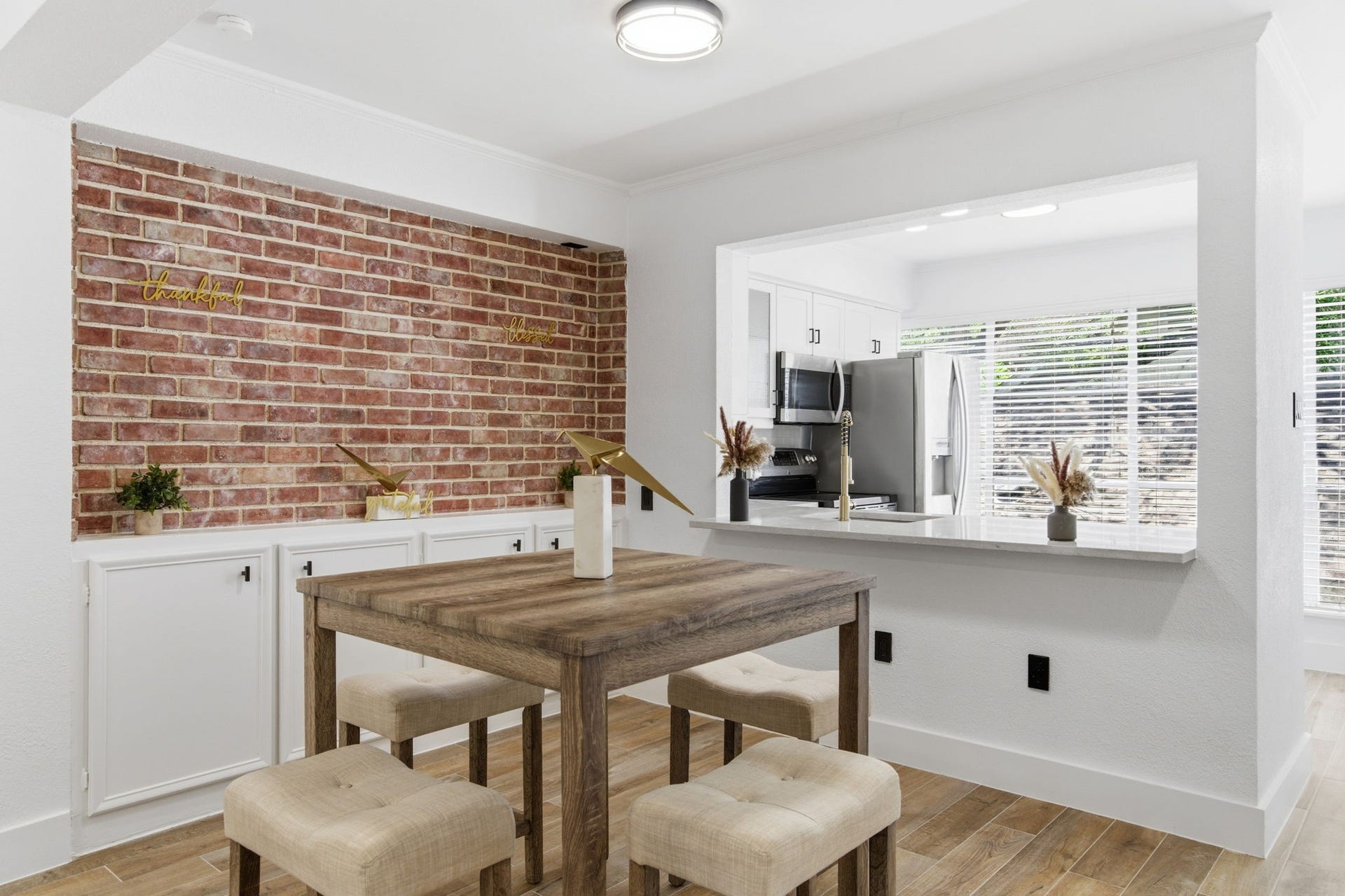 811 Lovett Boulevard, #21, Houston, TX 77006 The dining area has real character, with an exposed brick wall, built in cabinetry, and an open connection to the kitchen.