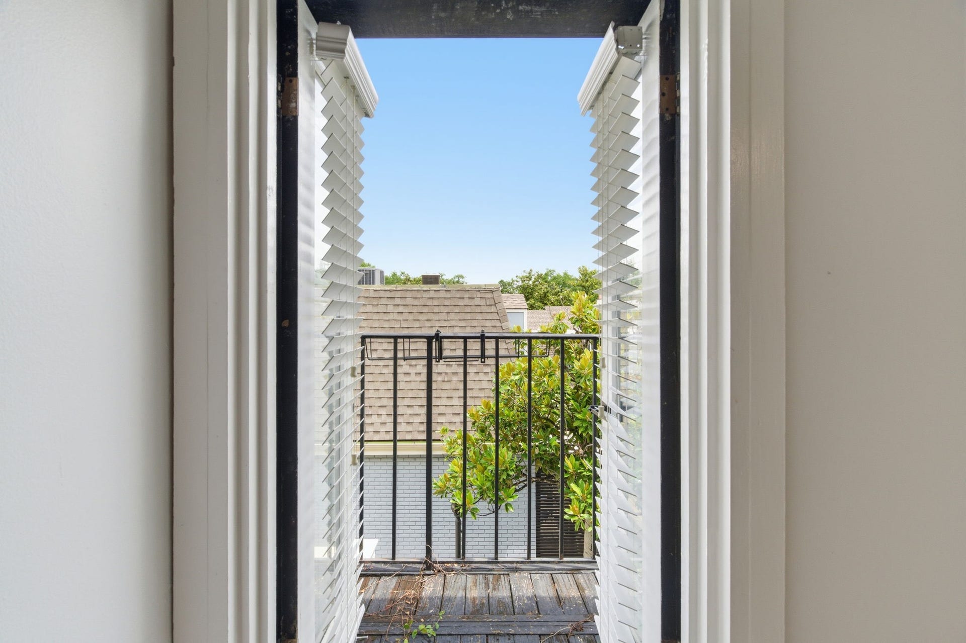 811 Lovett Boulevard, #21, Houston, TX 77006 Open the shuttered doors and step directly from the primary bedroom onto the private balcony.