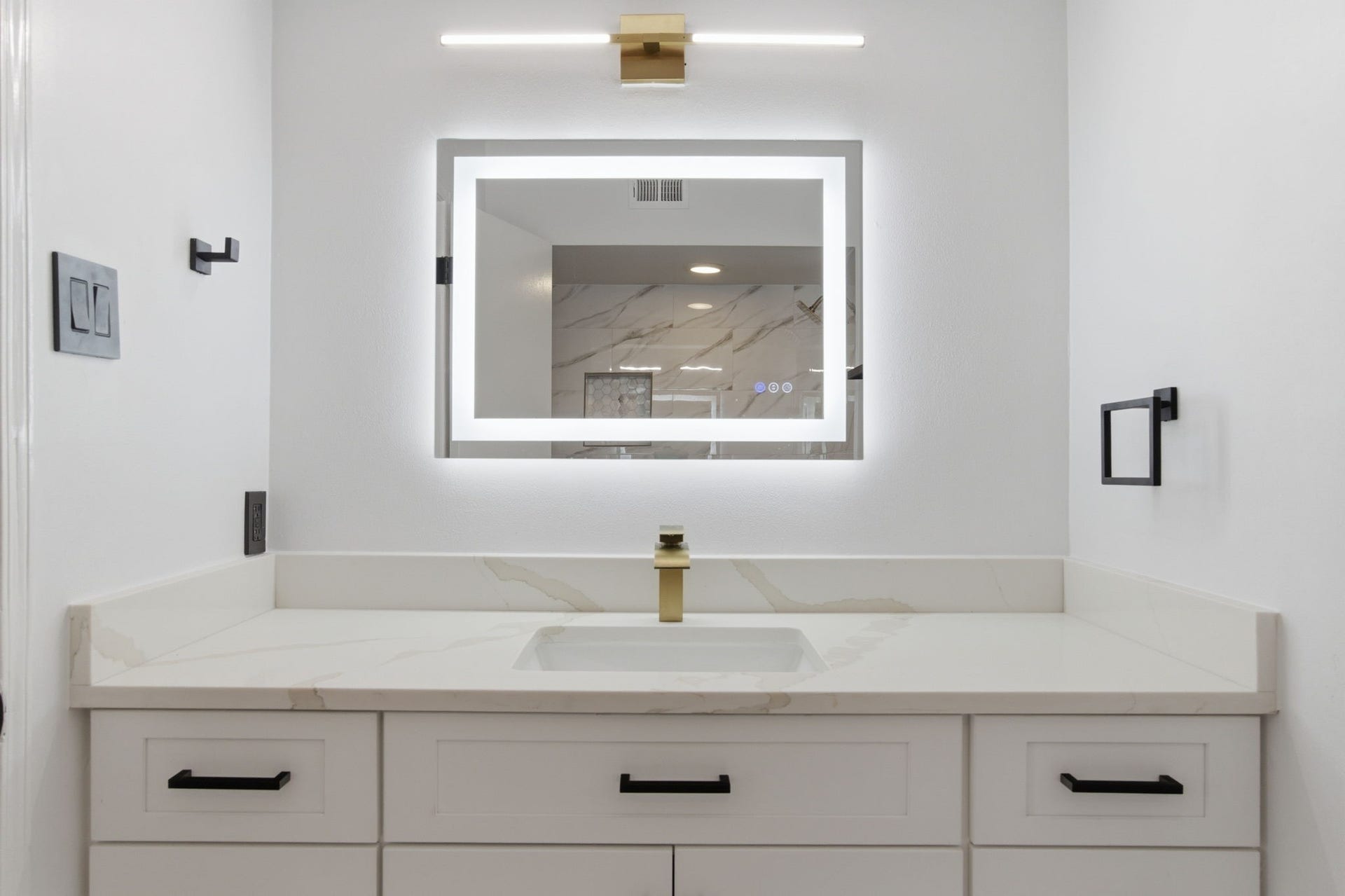 811 Lovett Boulevard, #21, Houston, TX 77006 The vanity offers plenty of storage and counter space while the layered lighting adds a more finished feel.