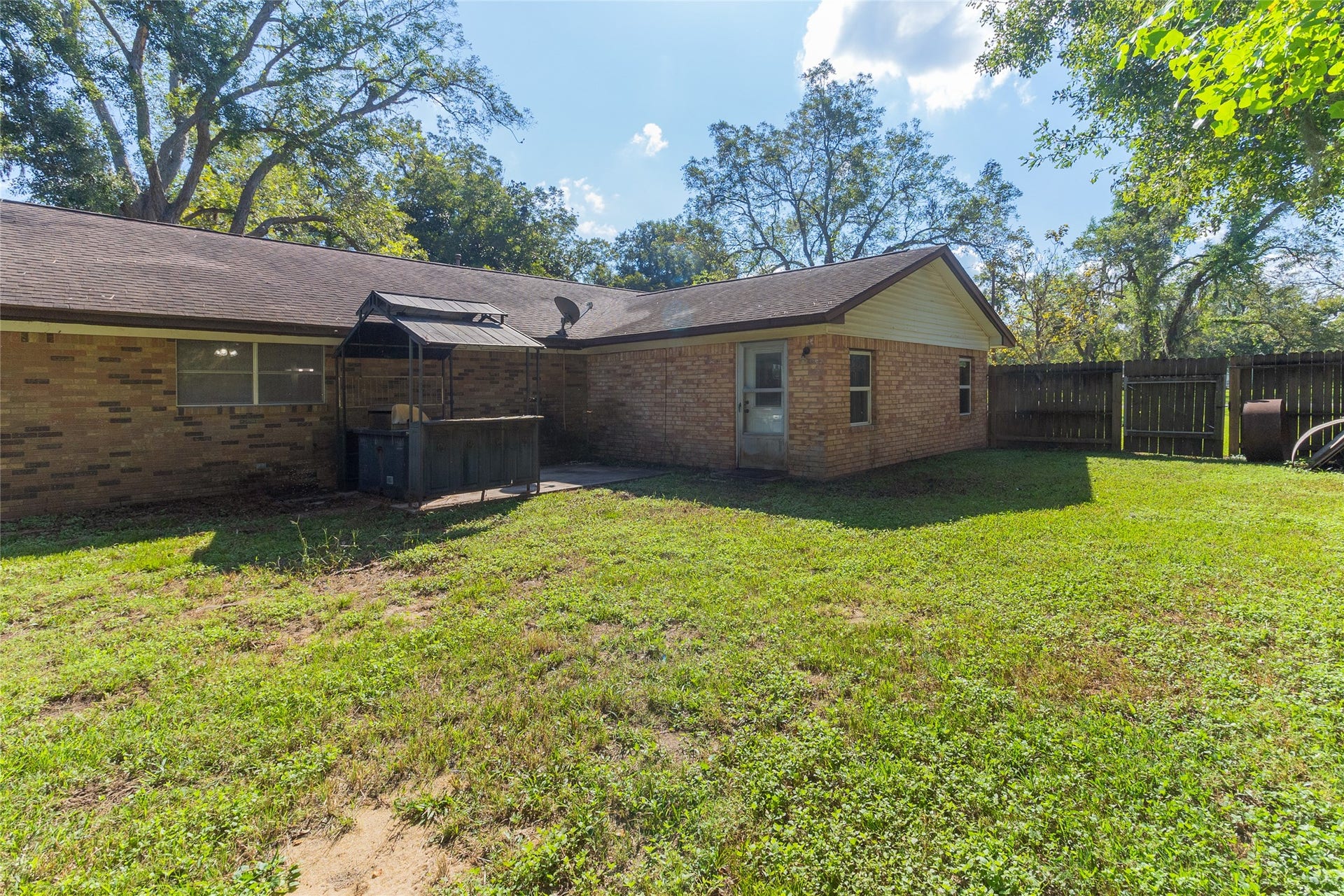 404 S 14th Street, West Columbia, TX 77486 A fenced backyard offers usable space for pets, play equipment or a garden, with room to personalize your outdoor setup.