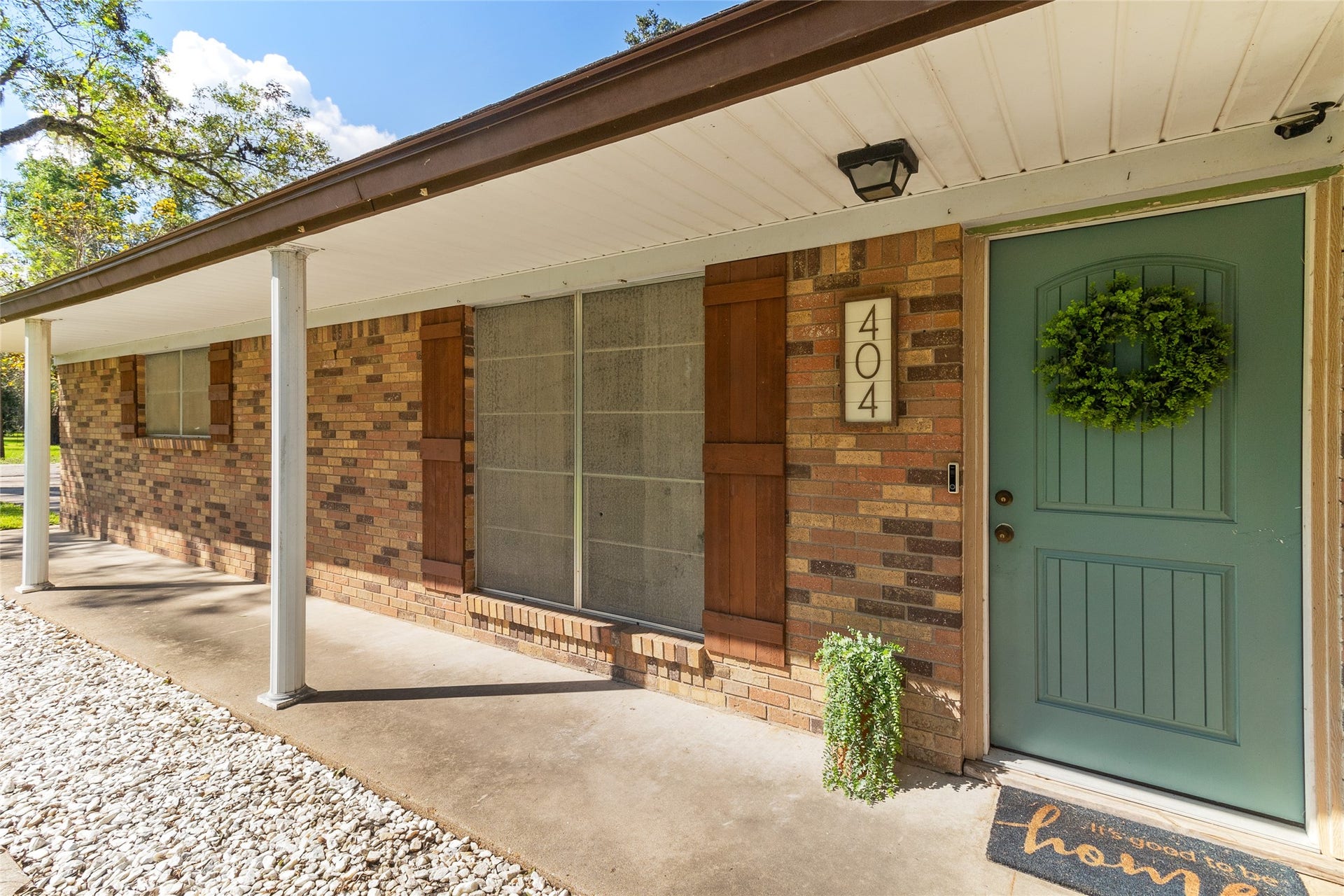 404 S 14th Street, West Columbia, TX 77486 Covered front porch offers space for holiday decor, with the front door replaced and shutters added in 2022 refreshing the homes exterior.