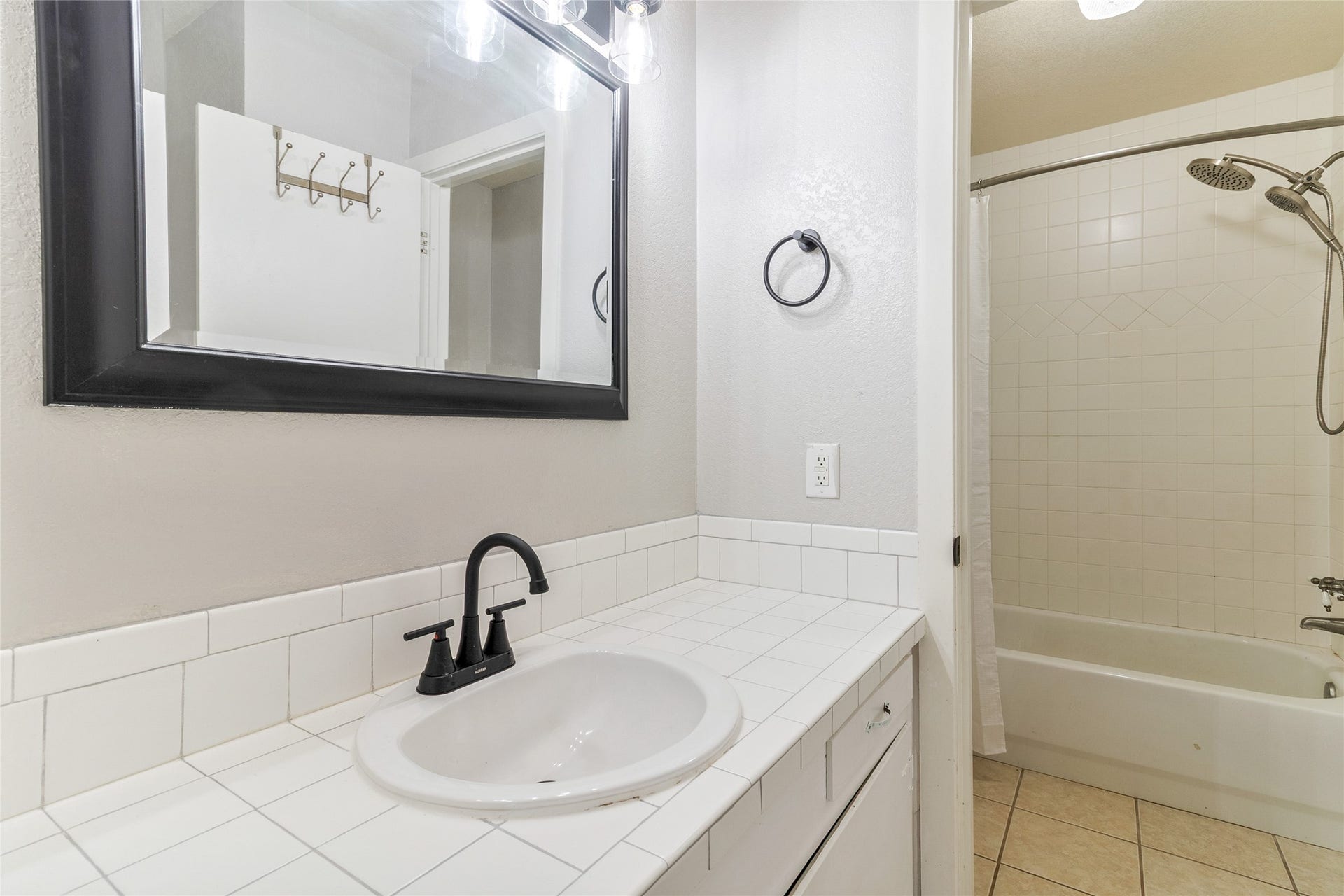 404 S 14th Street, West Columbia, TX 77486 Reconfigured in 2025, the private primary ensuite features a separate vanity area leading to a tub/shower combination, built-in storage and a window for natural light.