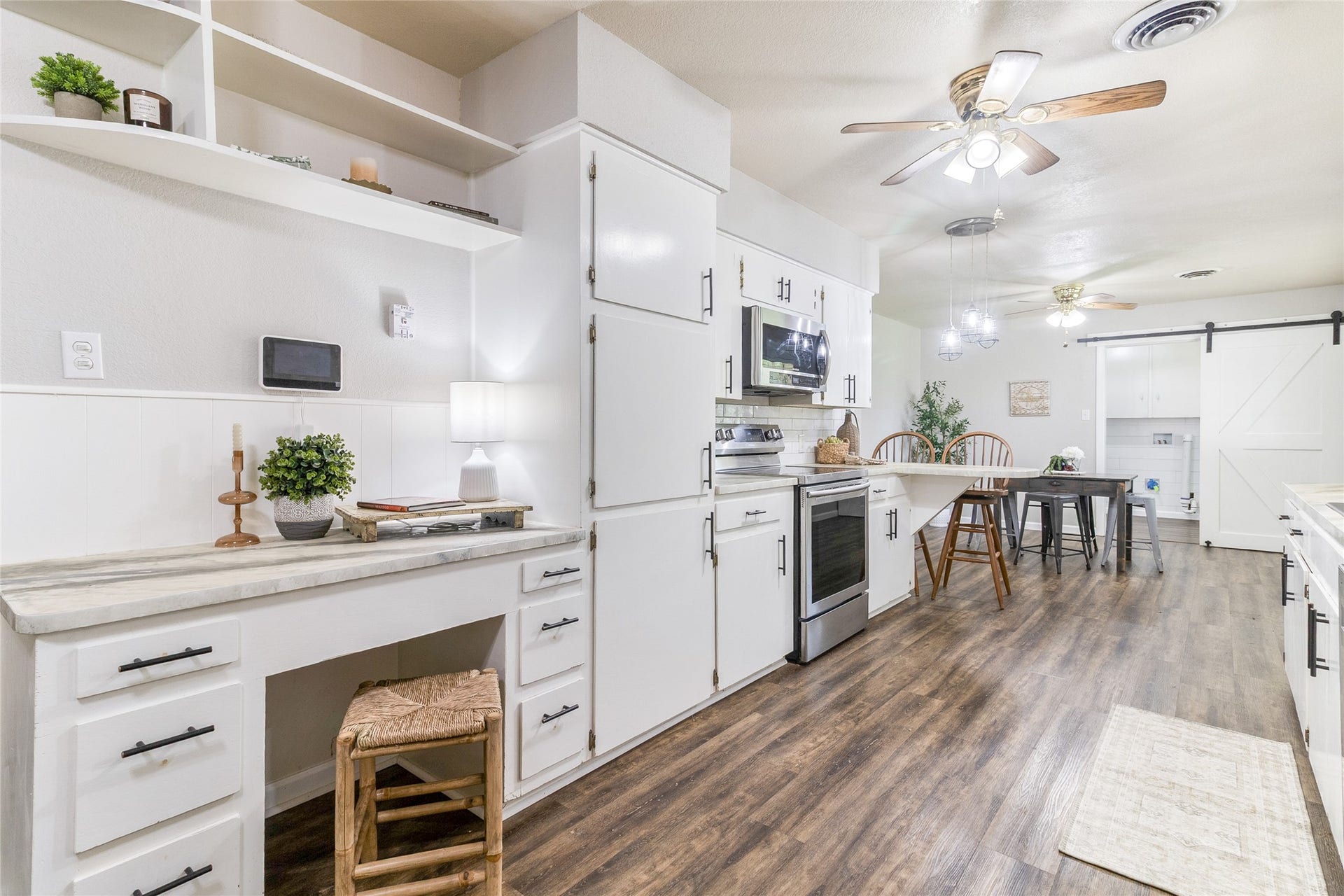 404 S 14th Street, West Columbia, TX 77486 White cabinetry with updated hardware keeps essentials organized, while open shelving offers display space. Vivint security system and control screen included.