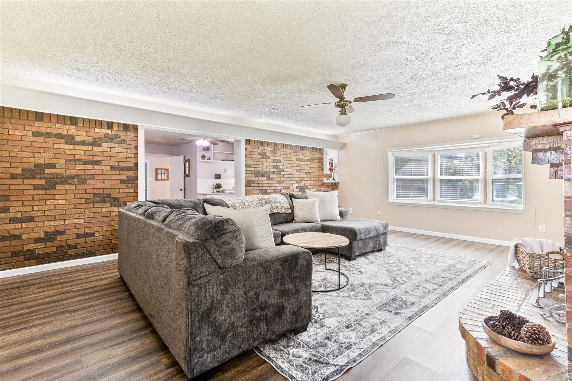 404 S 14th Street, West Columbia, TX 77486 Gather around the brick fireplace with gas connections, the family rooms focal point, while bay windows (2022) fill the space with natural light and backyard views.