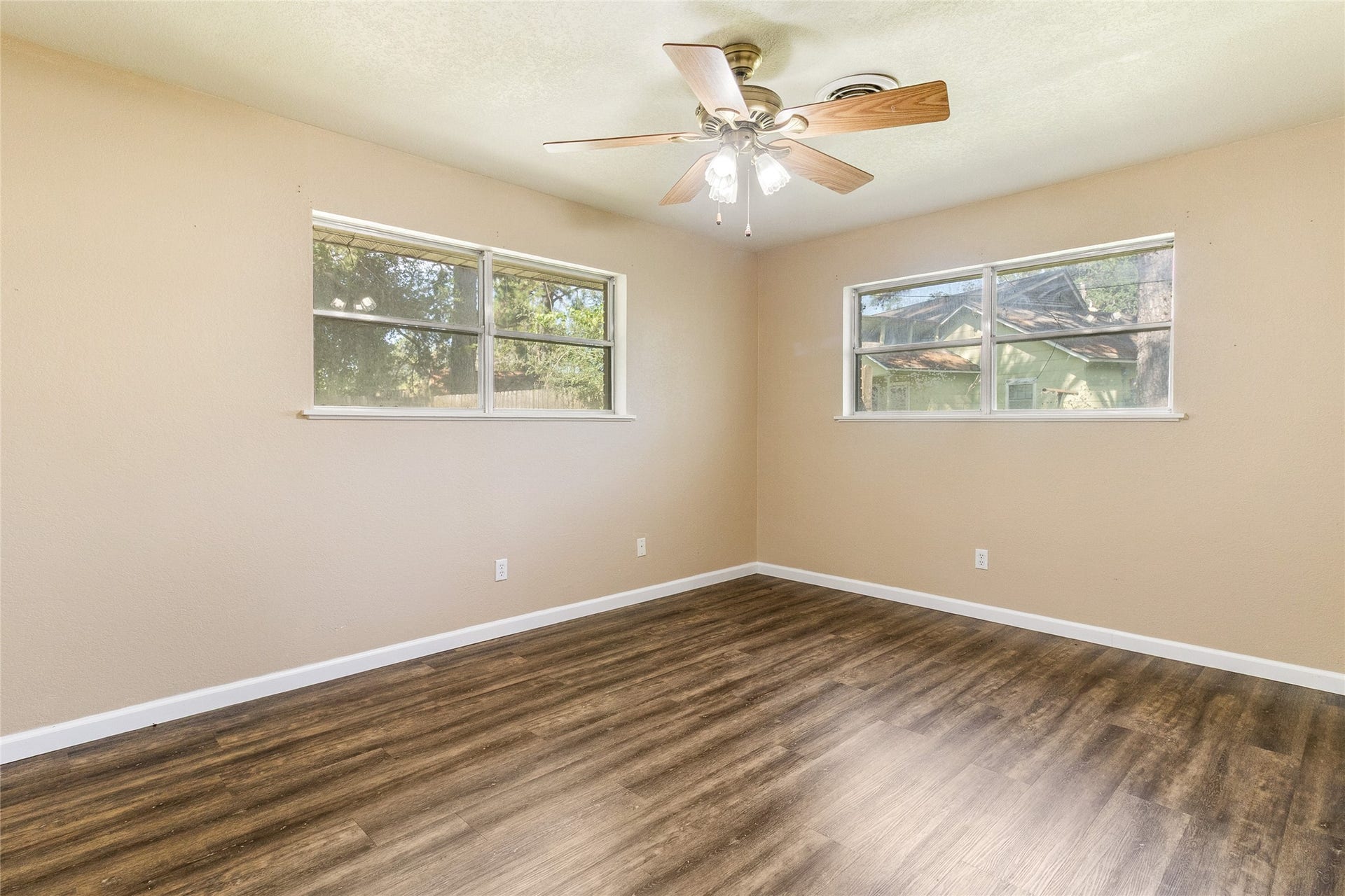404 S 14th Street, West Columbia, TX 77486 Bedroom #2 (14x11) offers generous space and high-set corner windows with backyard views, preserving wall space for flexible furniture arrangements.
