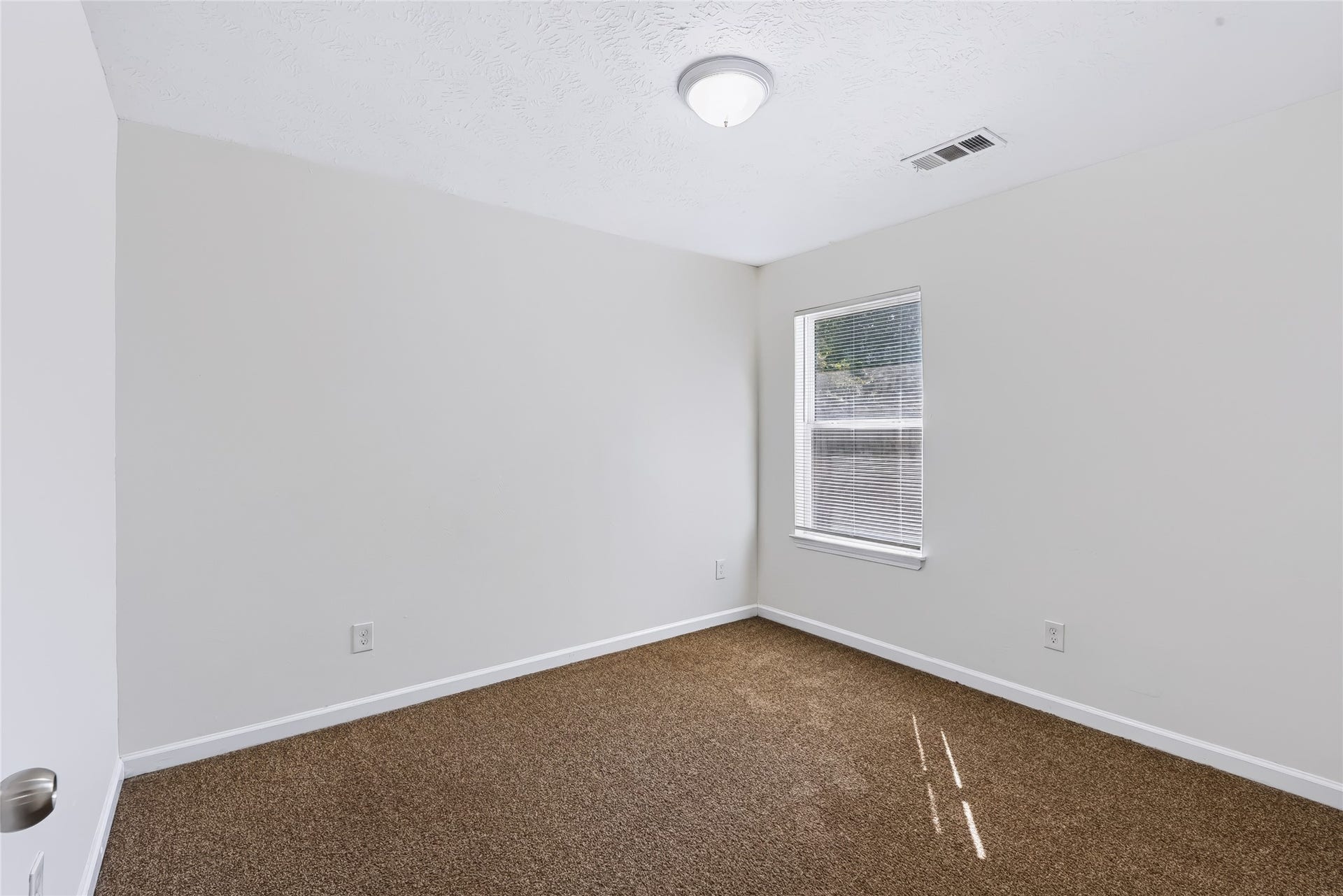 6528 Utah Street, Houston, TX 77091 Cozy bedroom featuring neutral walls, plush carpeting, and a window for natural light.