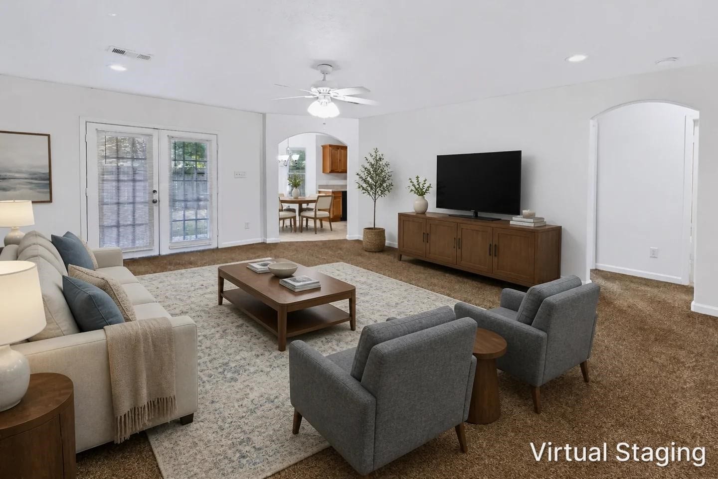 6528 Utah Street, Houston, TX 77091 Spacious living room with plush carpet, neutral tones, and ample natural light from French doors, featuring a cozy seating area.