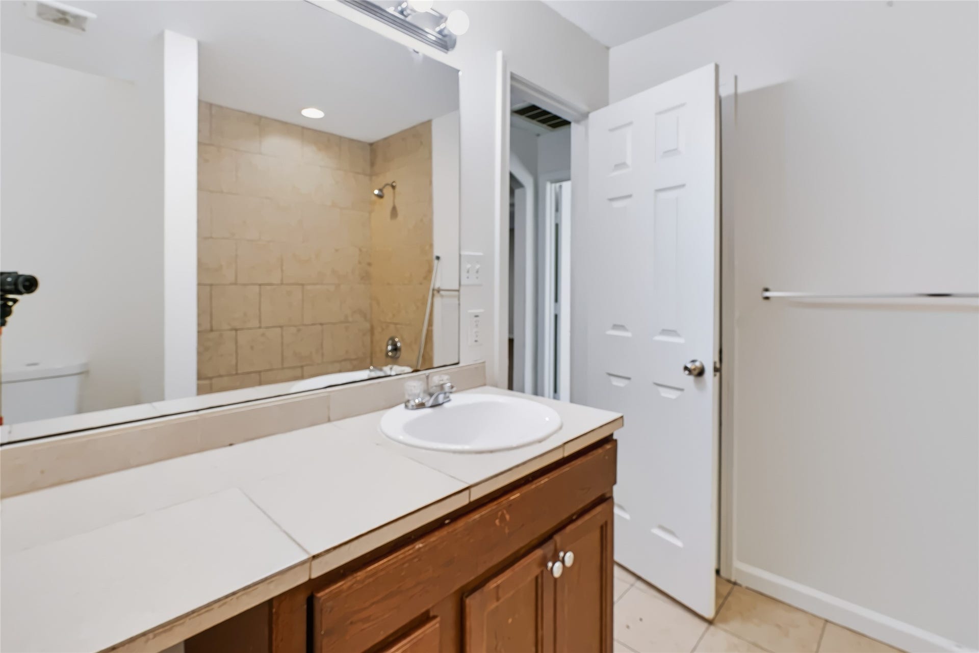 6528 Utah Street, Houston, TX 77091 Bright bathroom featuring a spacious vanity with a large mirror, tiled shower, and modern fixtures for a clean, contemporary look.