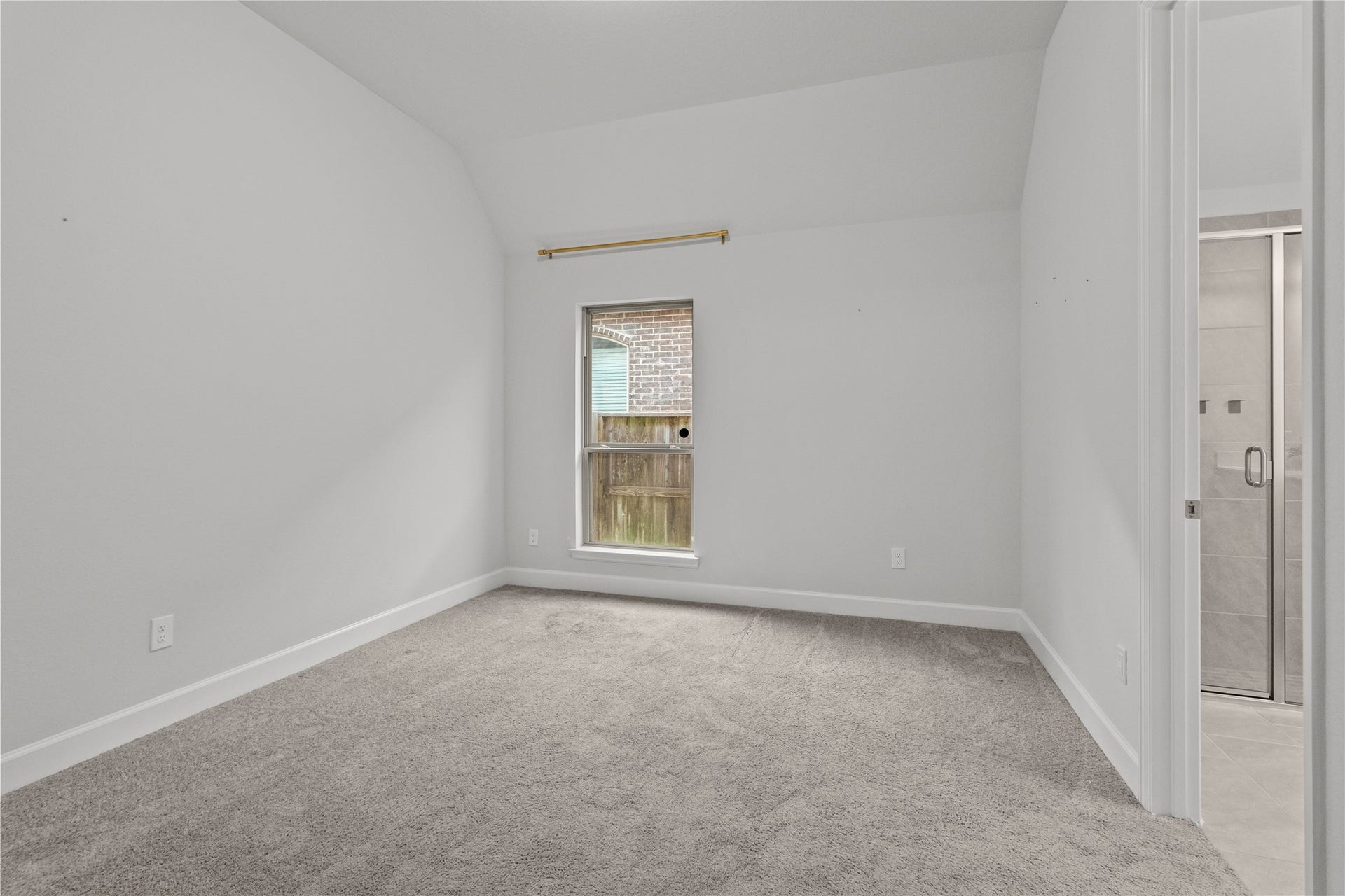 9934 Starry Night Lane, Manvel, TX 77578 Bright and cozy room with soft carpeting, a window for natural light, and an adjacent bathroom for convenience. Bedroom 2 with attached bathroom.