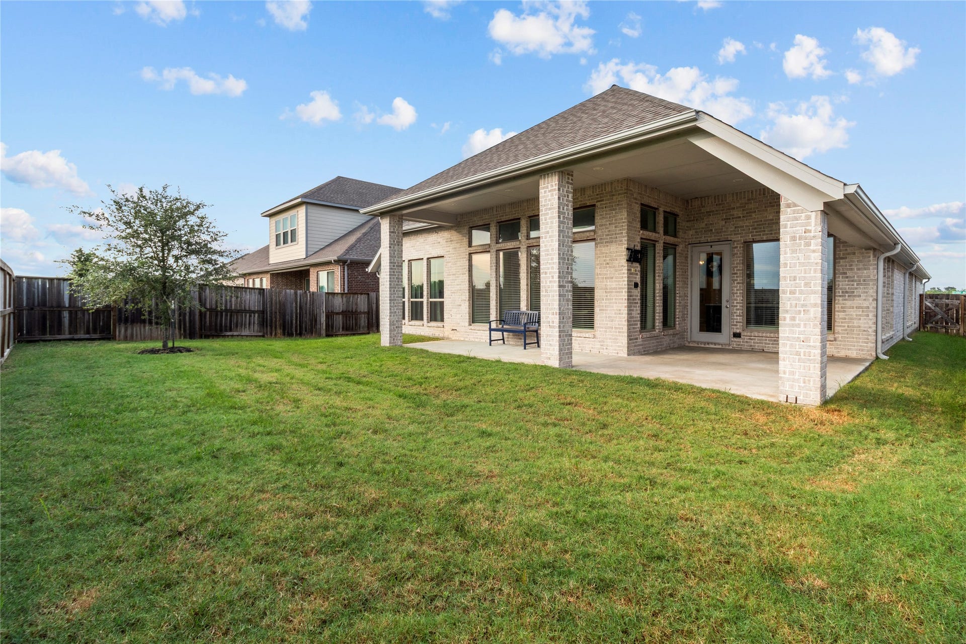 9934 Starry Night Lane, Manvel, TX 77578 Charming brick home with a spacious covered patio overlooking a lush, fenced backyardperfect for outdoor relaxation and entertaining.