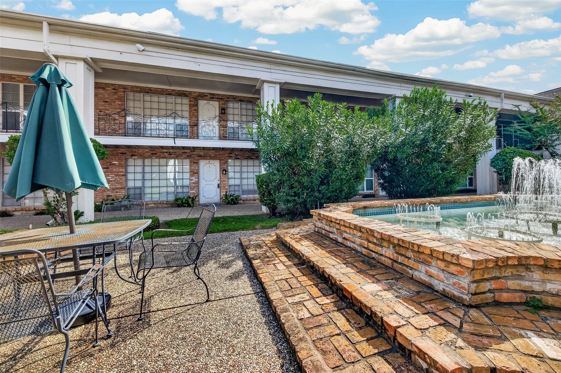 5343 Richmond Avenue, #4, Houston, TX 77056 Charming courtyard with a tranquil fountain, lush greenery, and a cozy seating area perfect for relaxation.