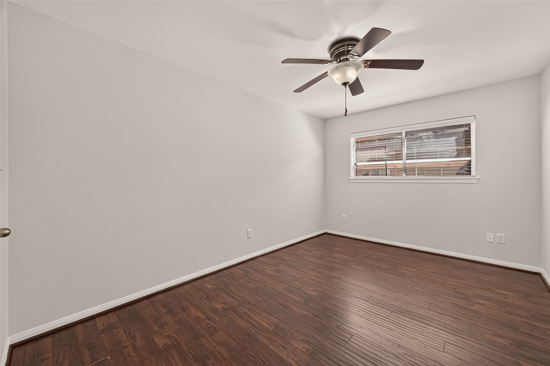 5343 Richmond Avenue, #4, Houston, TX 77056 Spacious bedroom with rich wood flooring, a ceiling fan, and ample natural light from the large window.