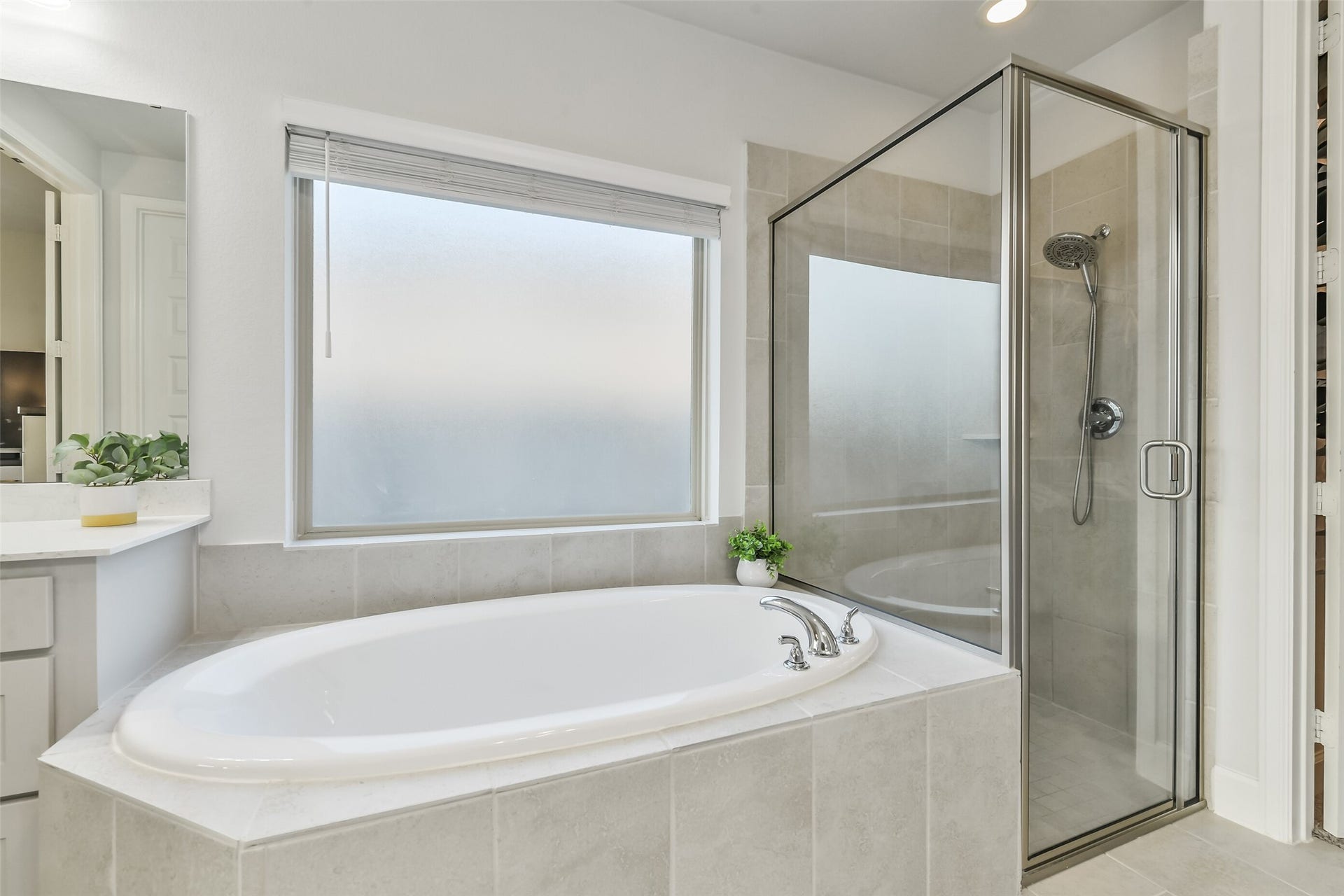 20815 Clydesdale Post Road, Tomball, TX 77377 The soaking tub features a large frosted window above for natural light.