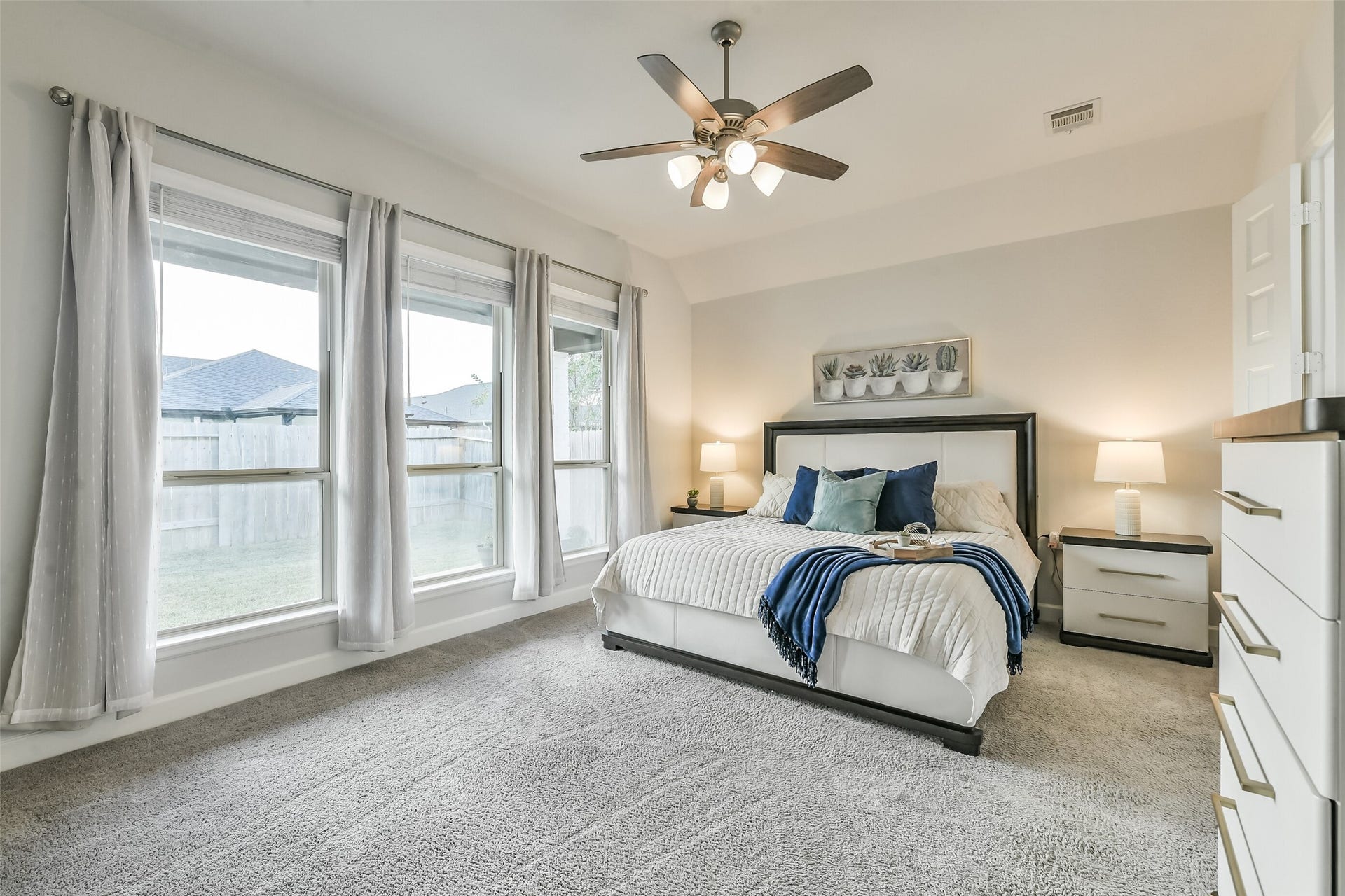 20815 Clydesdale Post Road, Tomball, TX 77377 Directly off the living room is the gorgeous primary bedroom featuring a ceiling fan and several windows with full blinds for added privacy.