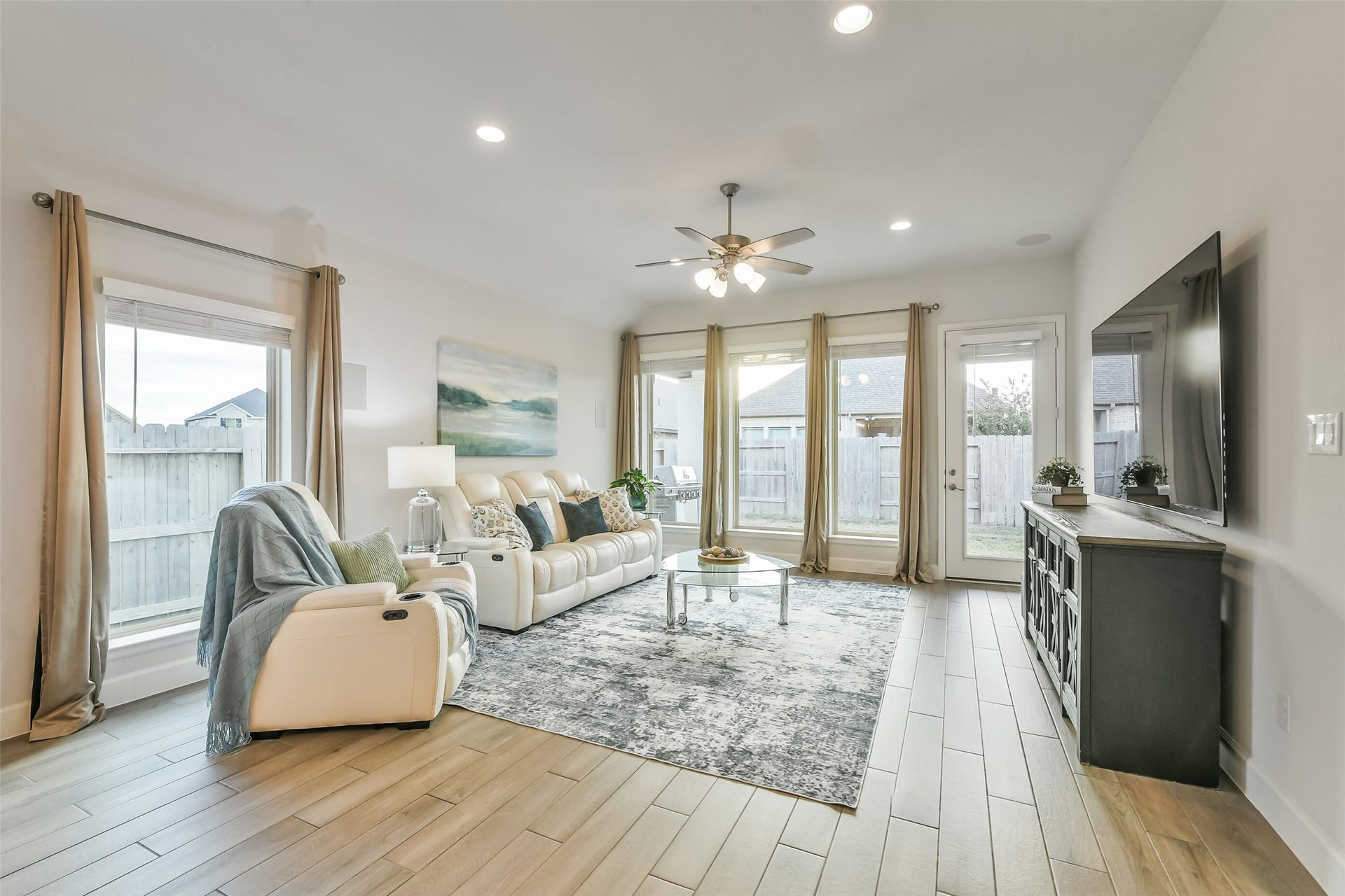 20815 Clydesdale Post Road, Tomball, TX 77377 This beautiful living room features multiple windows providing plenty of natural light in the space and a built-in speaker system.